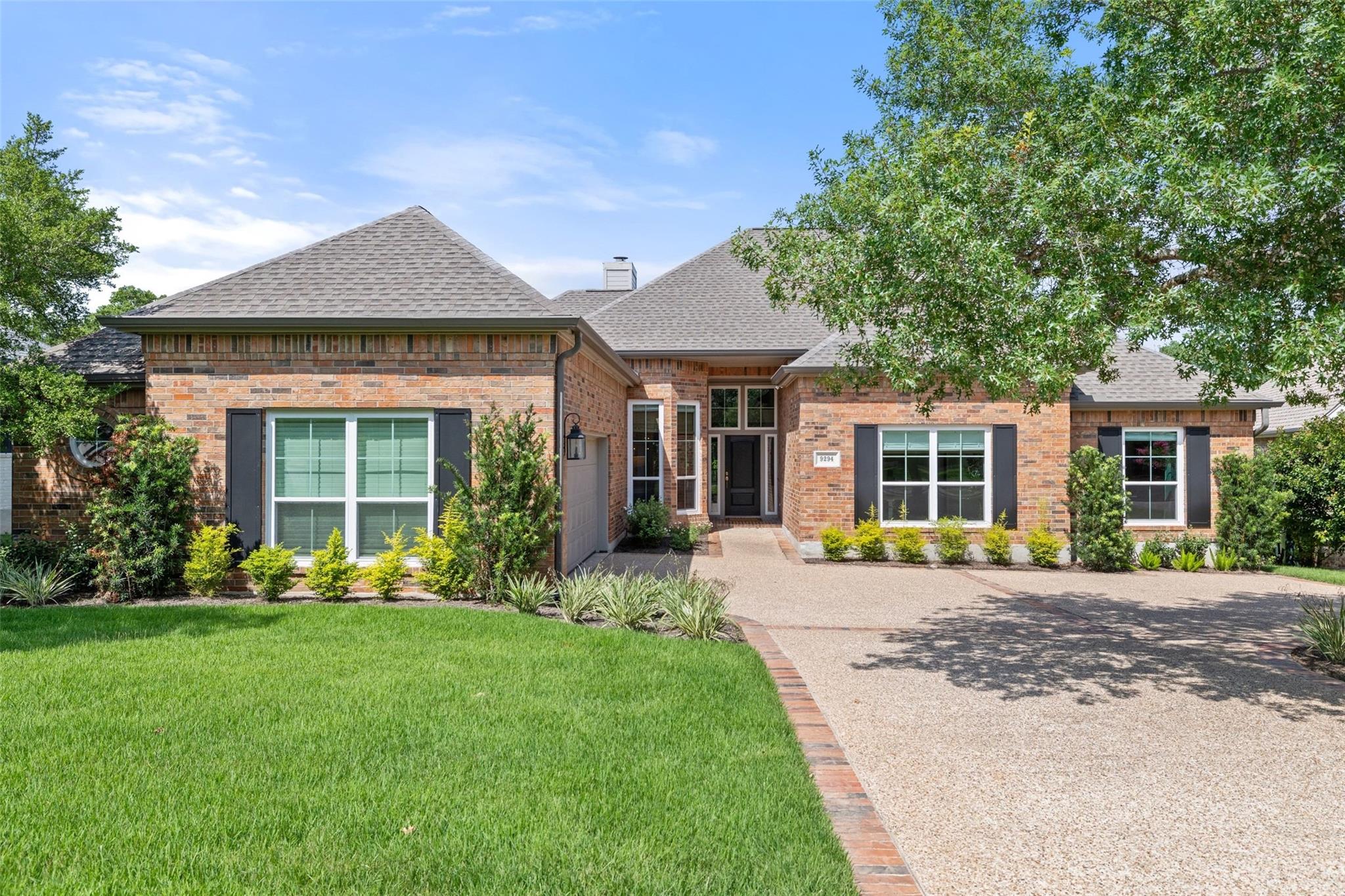 Brick facade with contrasting shutters welcomes y