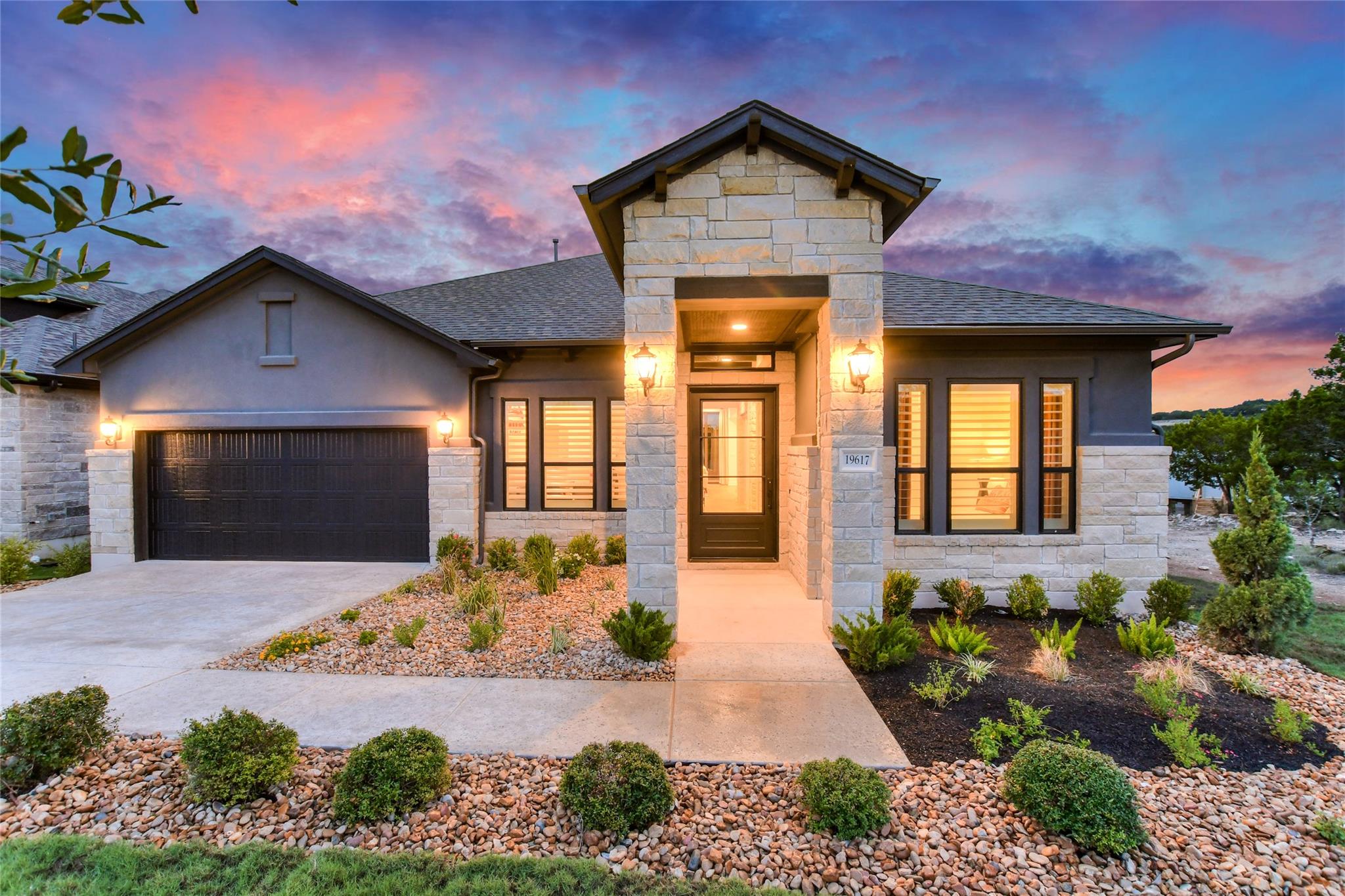 View of front of home featuring stone siding, an 