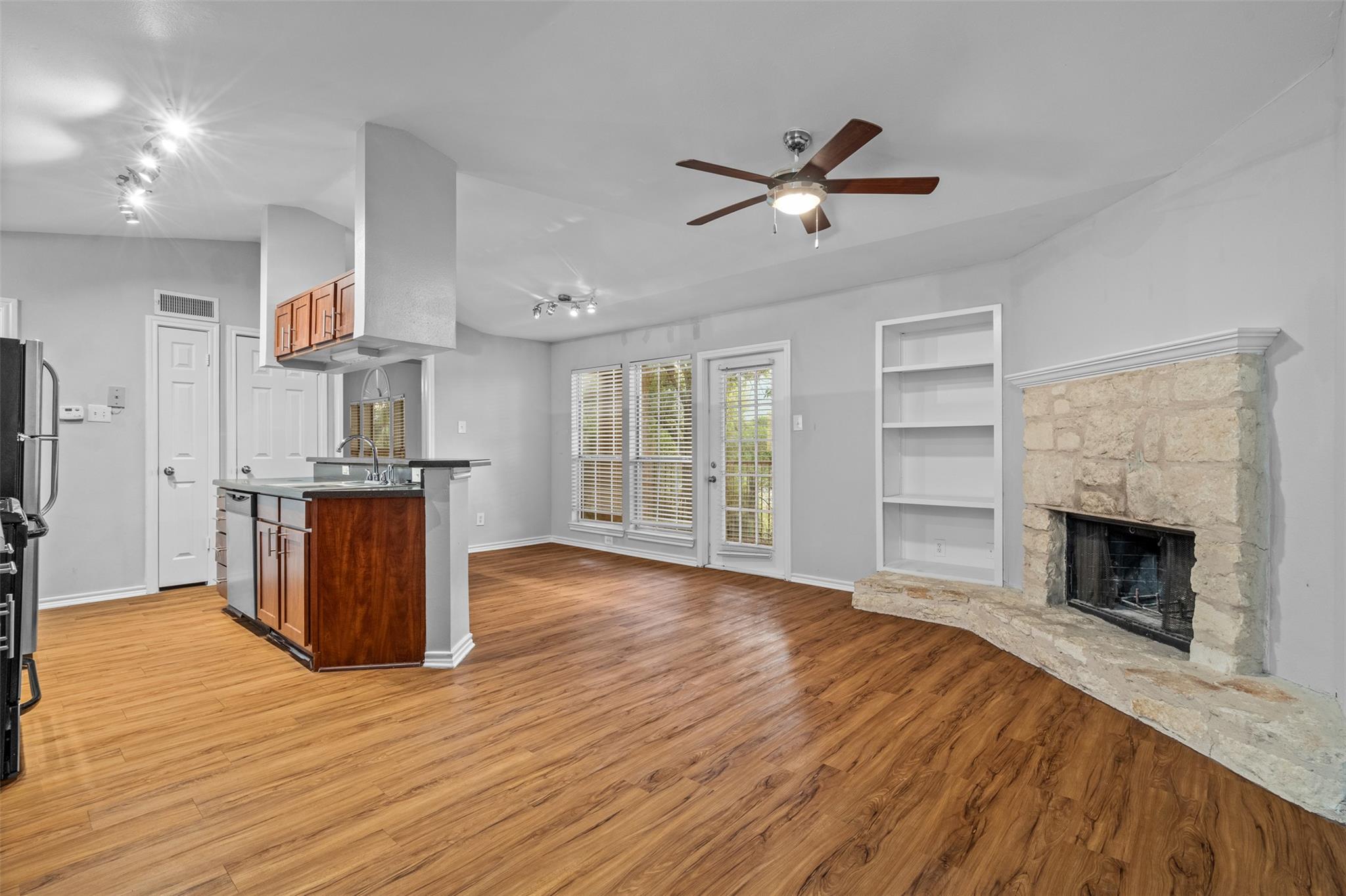 Open-concept living area featuring wood-finish fl