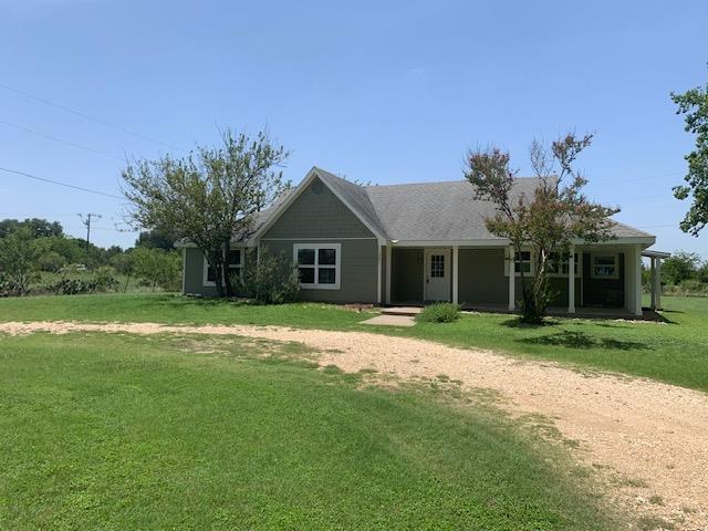 Ranch-style home with covered porch and a front l