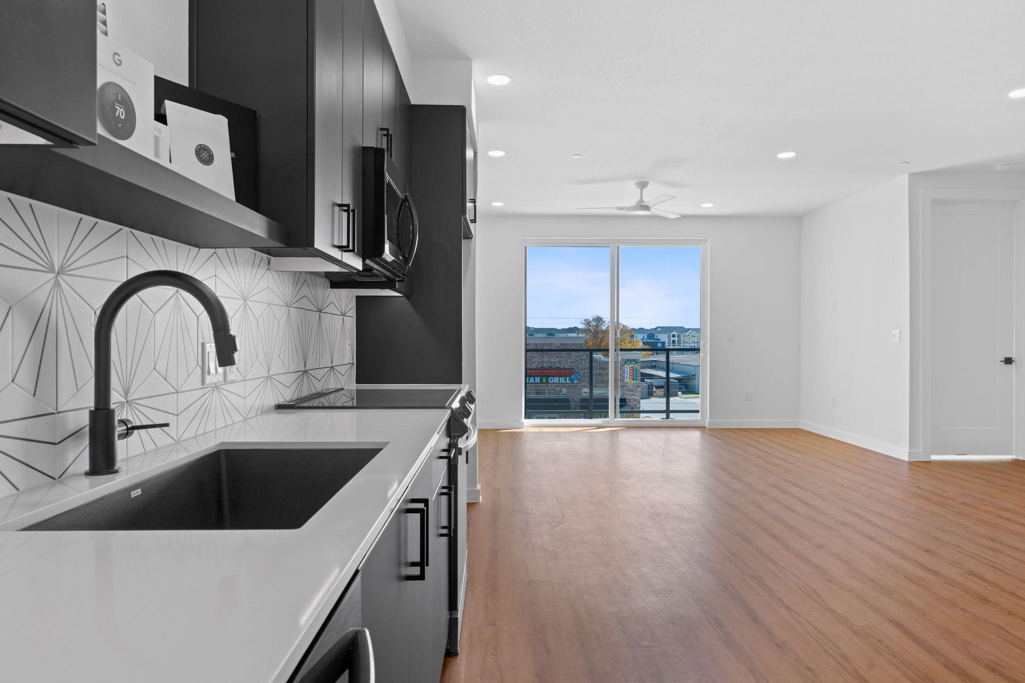Kitchen featuring dark cabinetry, stainless steel