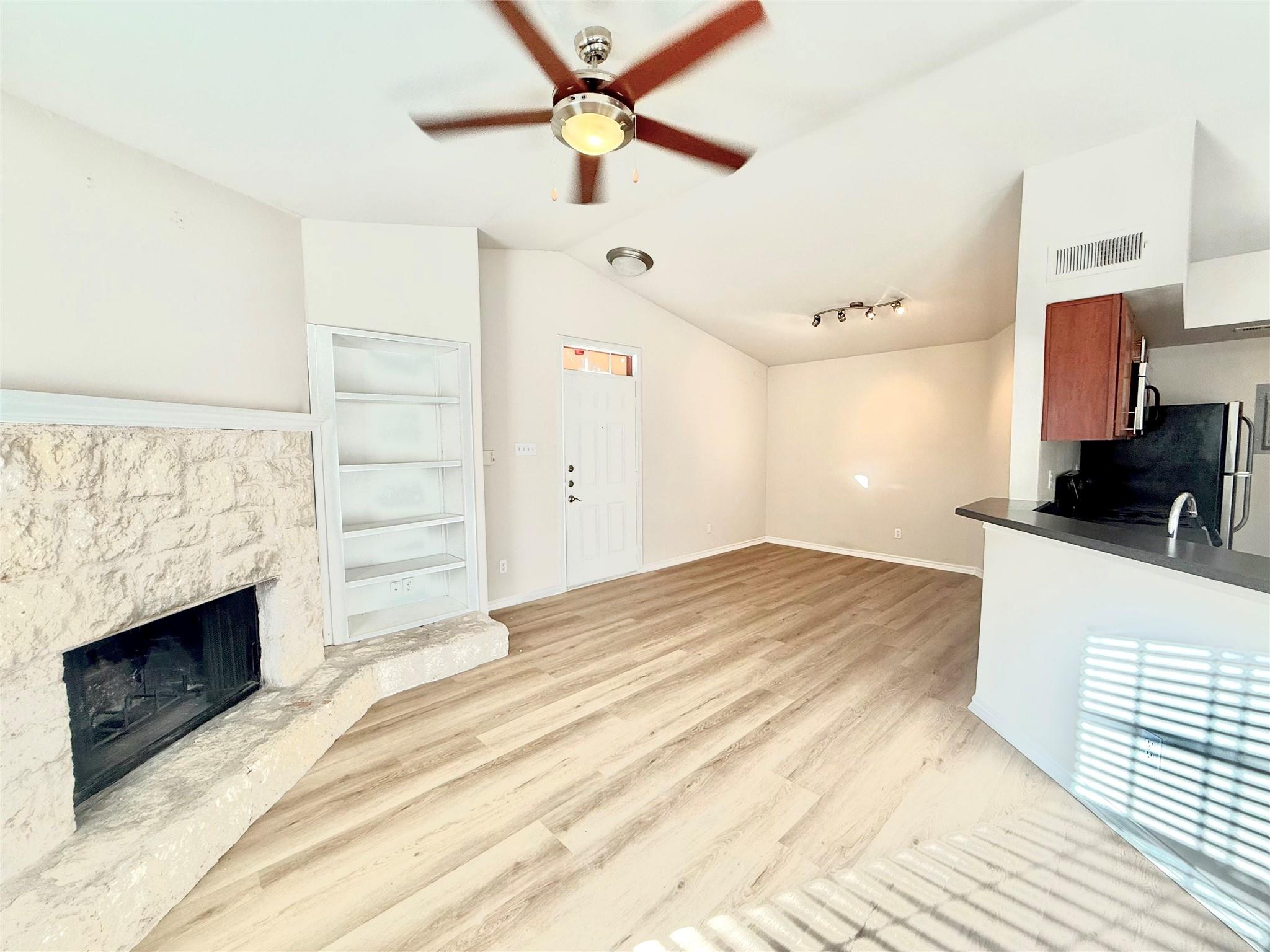 Unfurnished living room with a ceiling fan, lofte