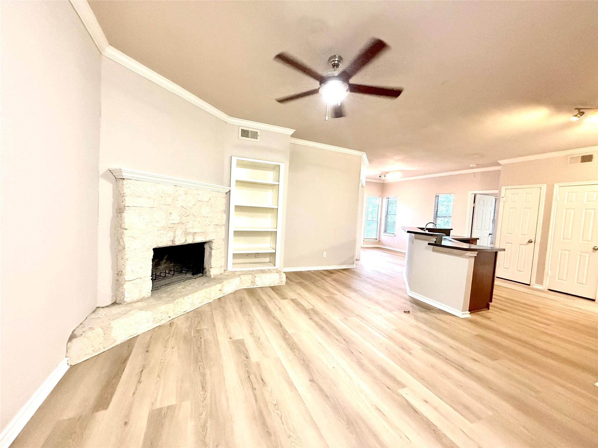 Unfurnished living room featuring crown molding, 