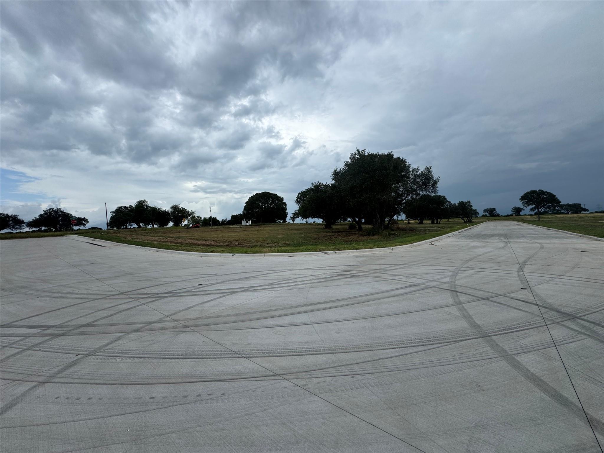 View of concrete road featuring curbs