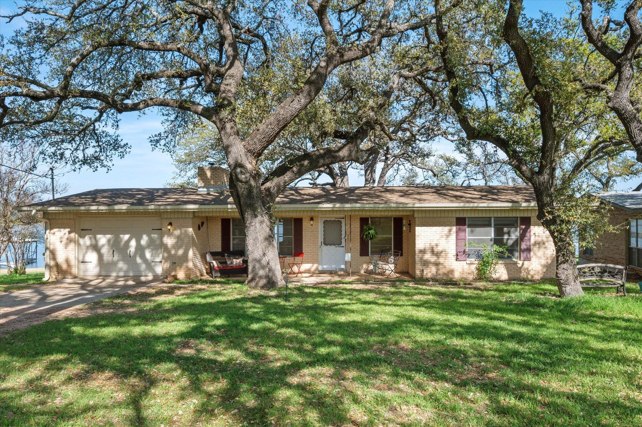 Ranch-style house featuring brick siding, an atta