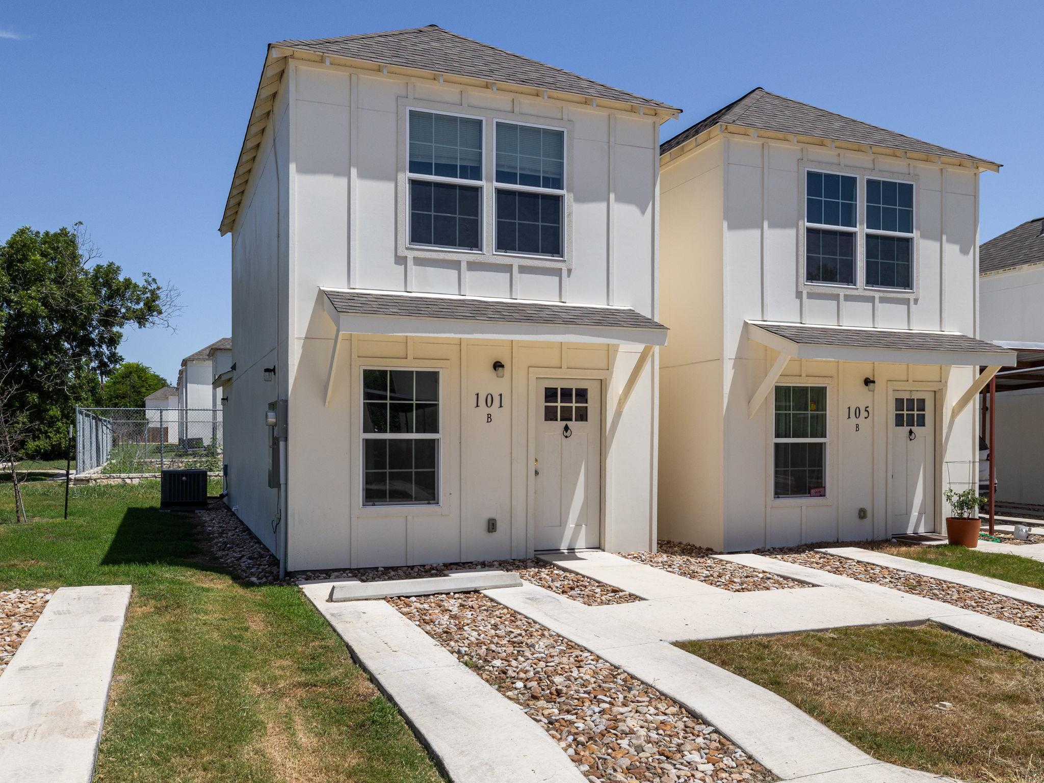 View of front of house with a shingled roof and b