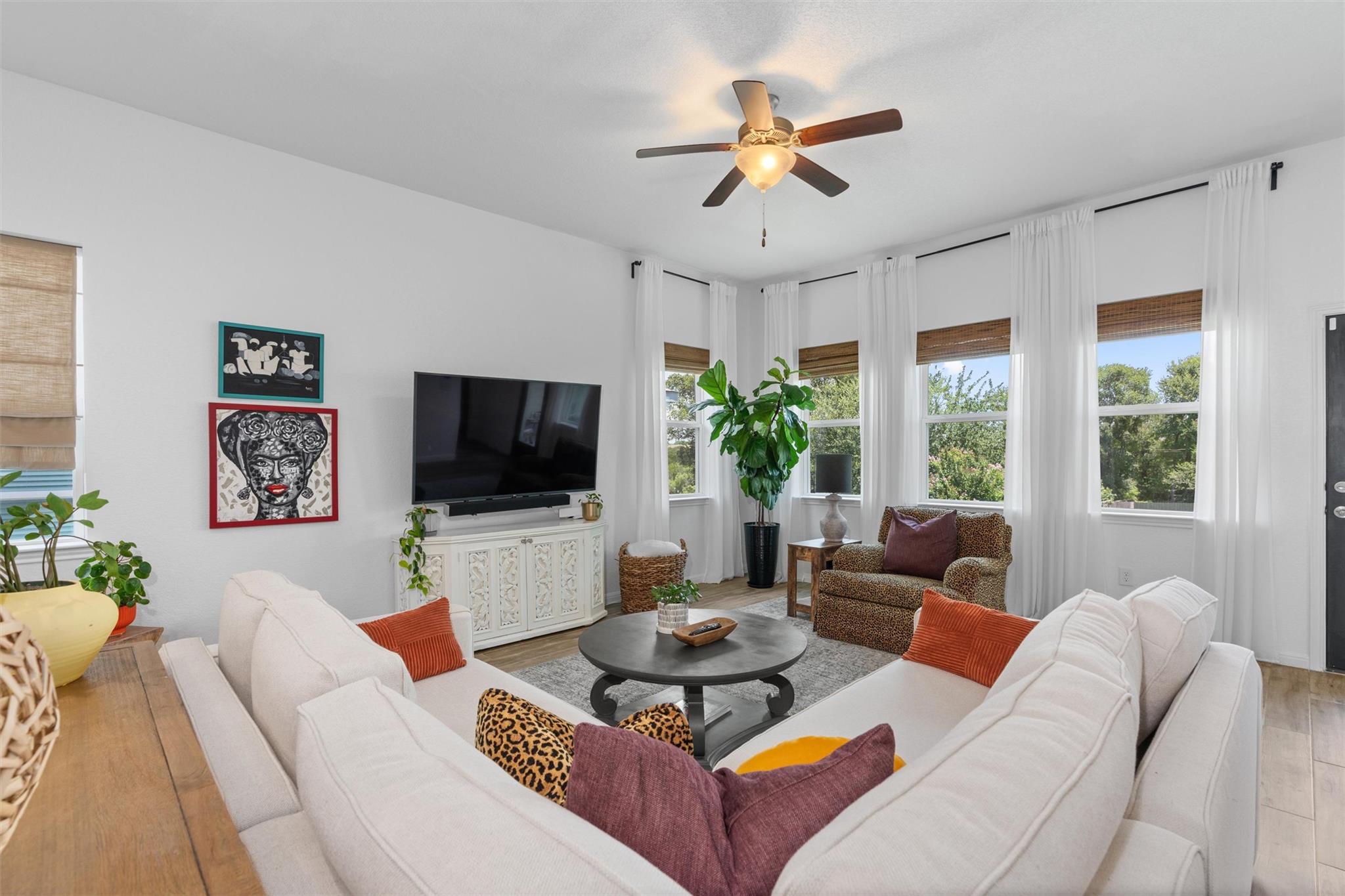 Living room with light wood-type flooring and cei
