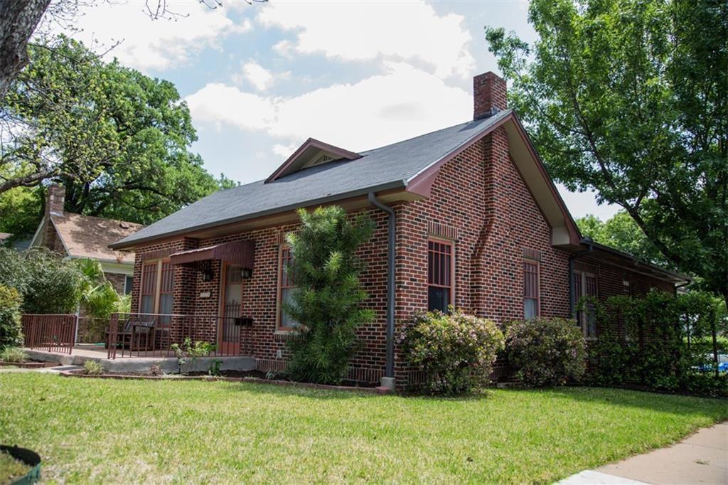 View of front of home with a chimney, brick sidin