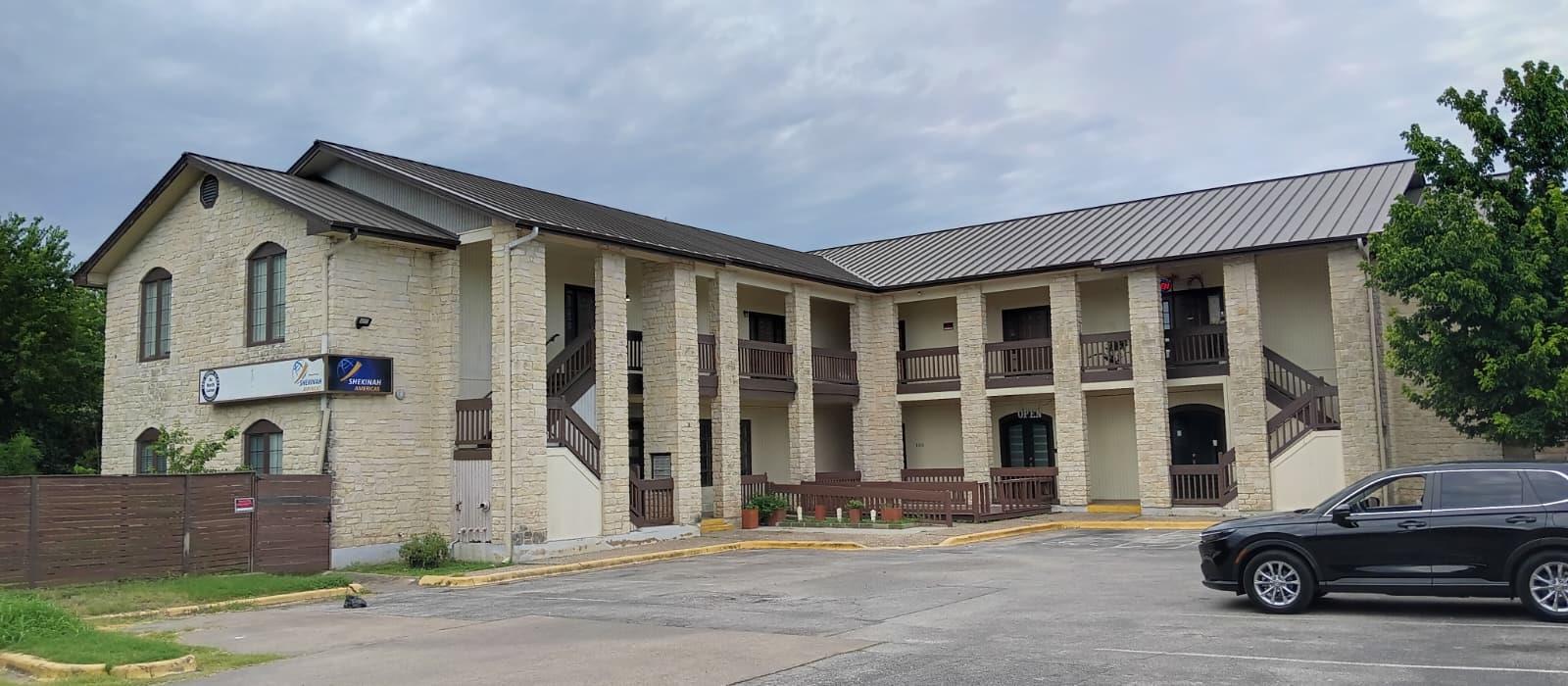 View of property with uncovered parking