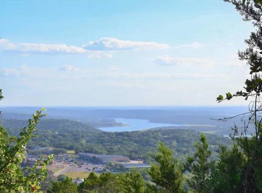 View of mountain backdrop featuring a nearby body