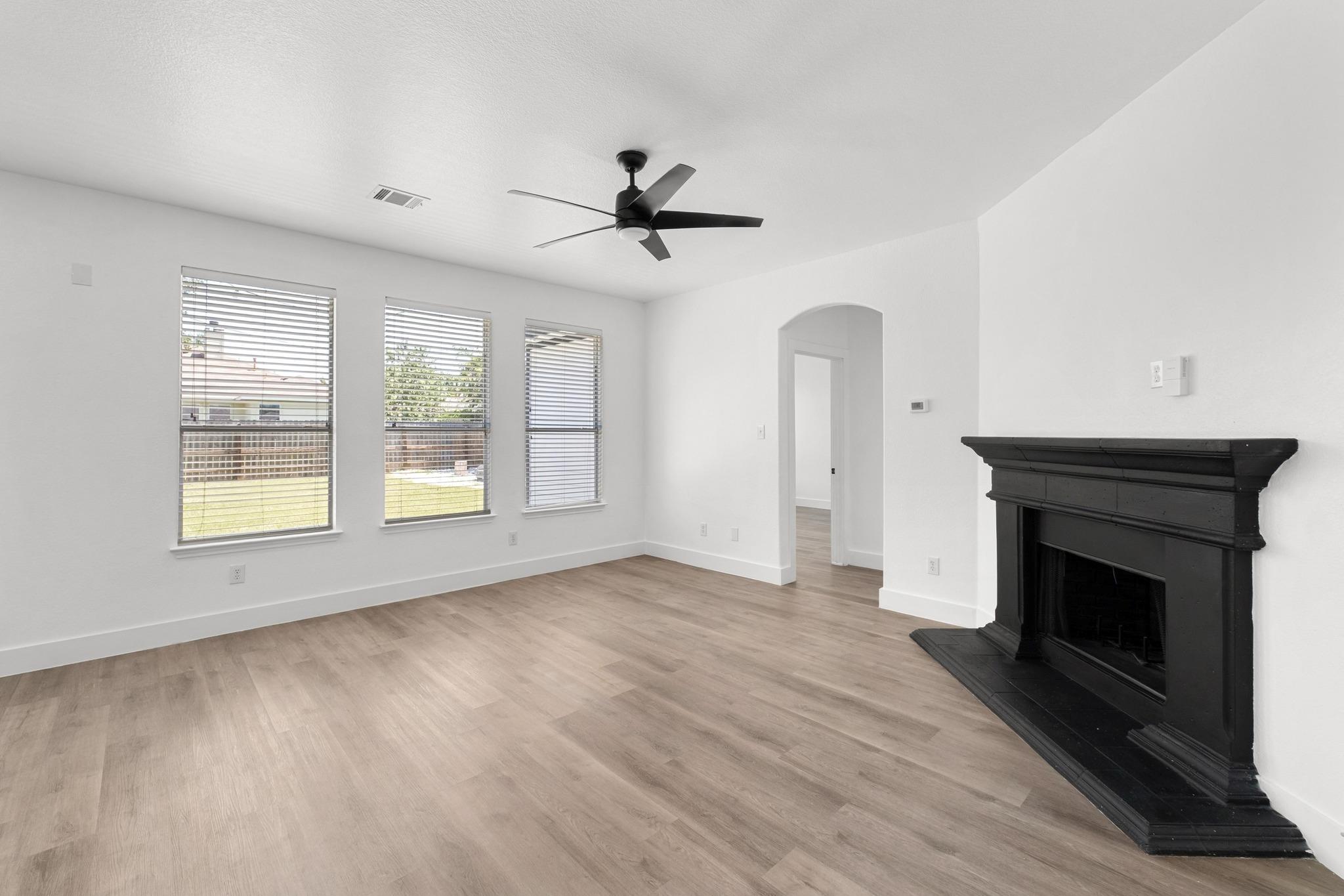 Unfurnished living room with a fireplace with rai