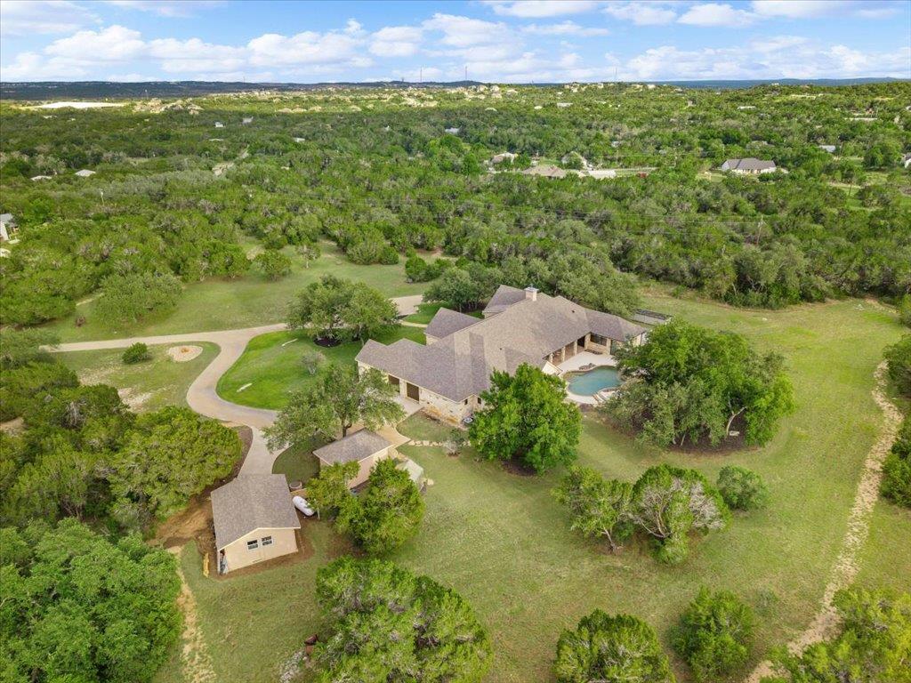 A sprawling estate sits nestled among mature tree