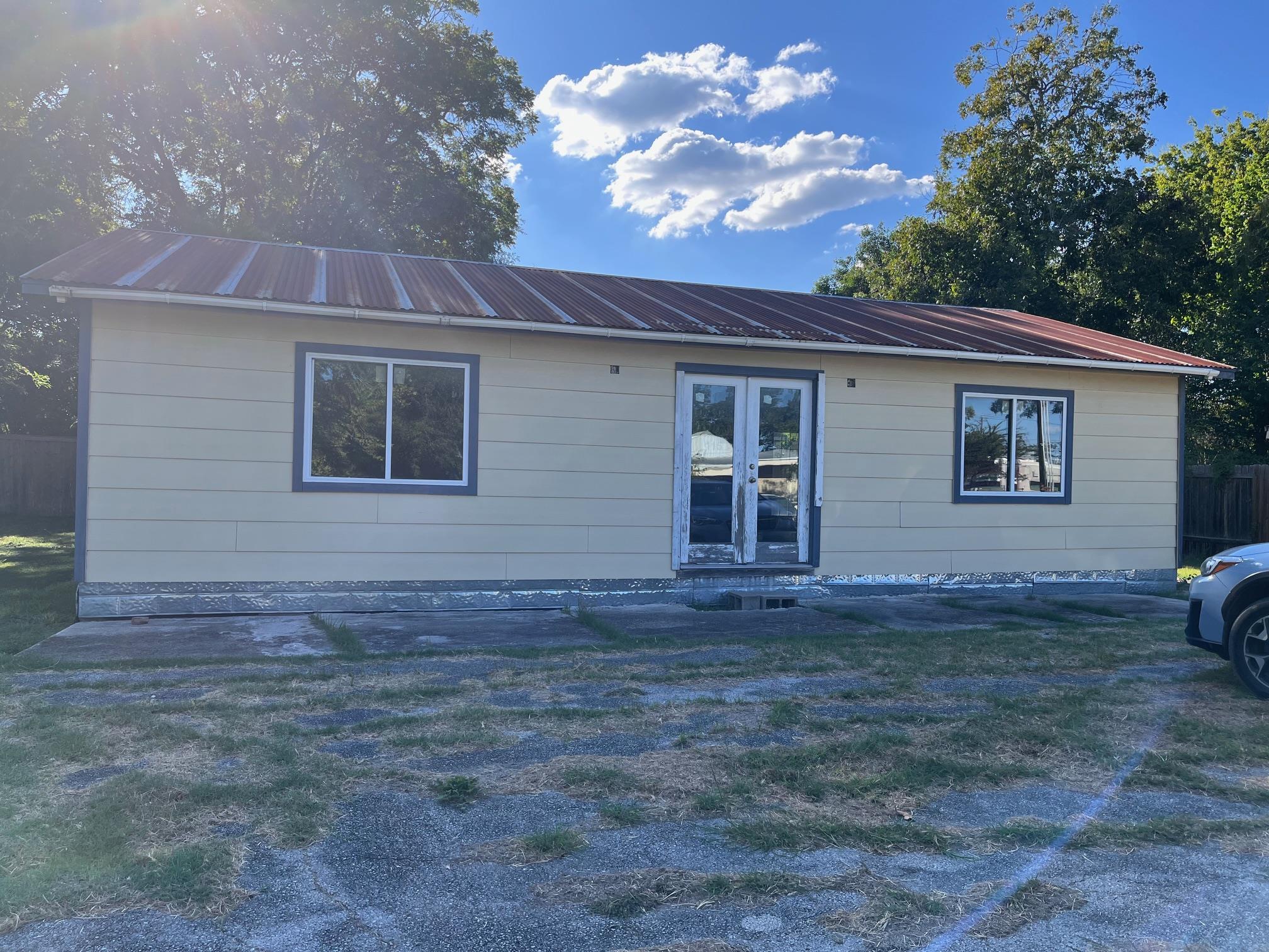 Rear view of property featuring a metal roof