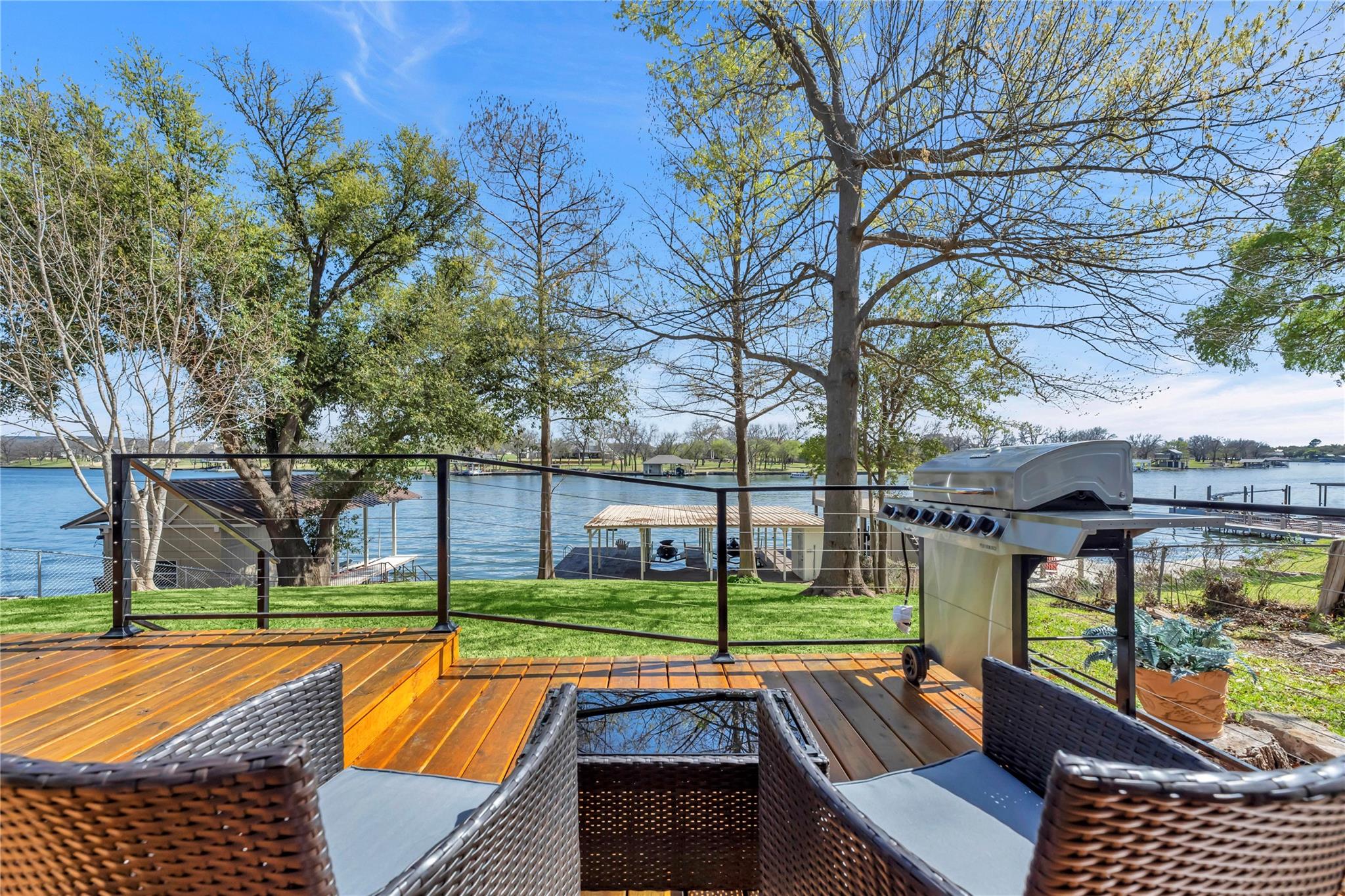 Wooden terrace featuring a water view, area for g
