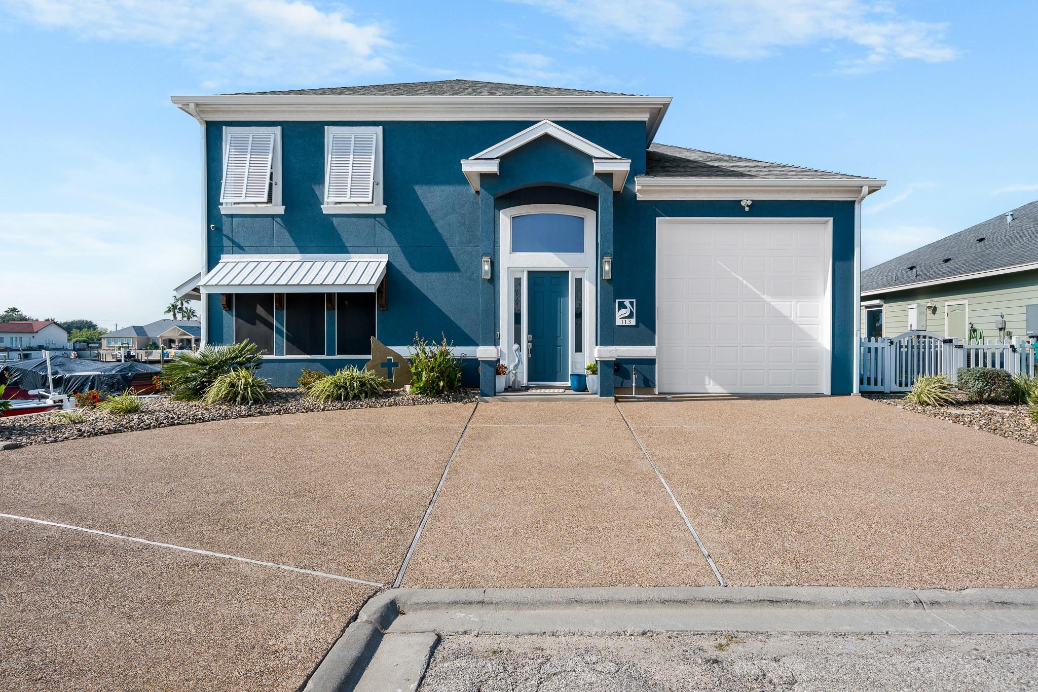 View of front facade with stucco siding, concrete