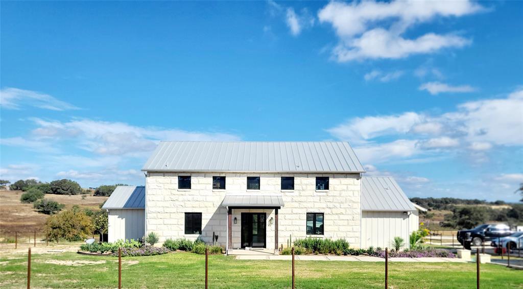Modern inspired farmhouse with a metal roof, a st