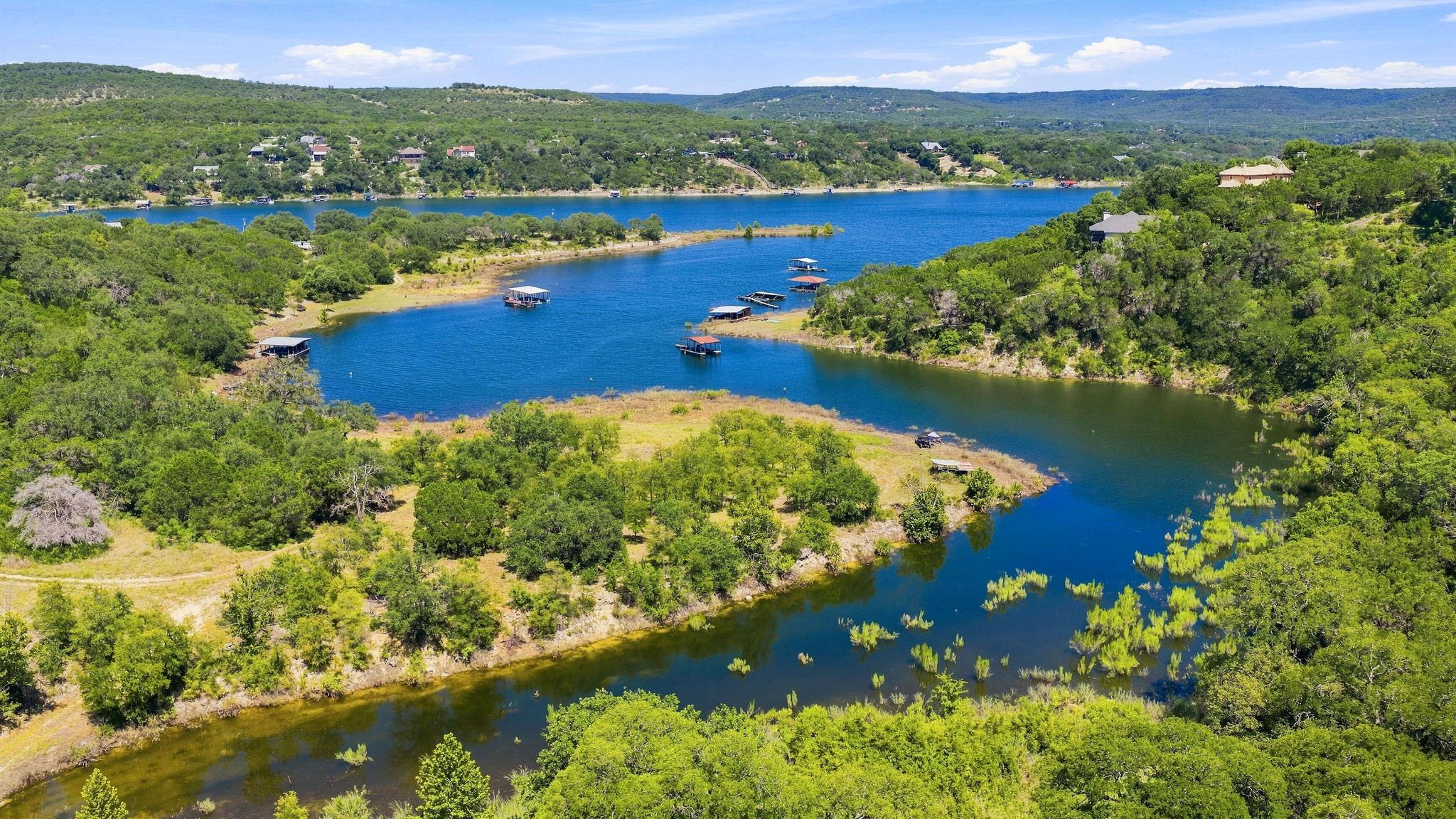 A tranquil lake view unfolds with lush green hill