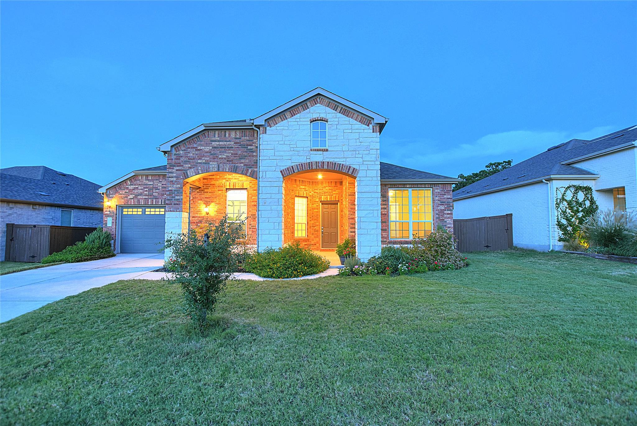 View of front of home with a garage, brick siding