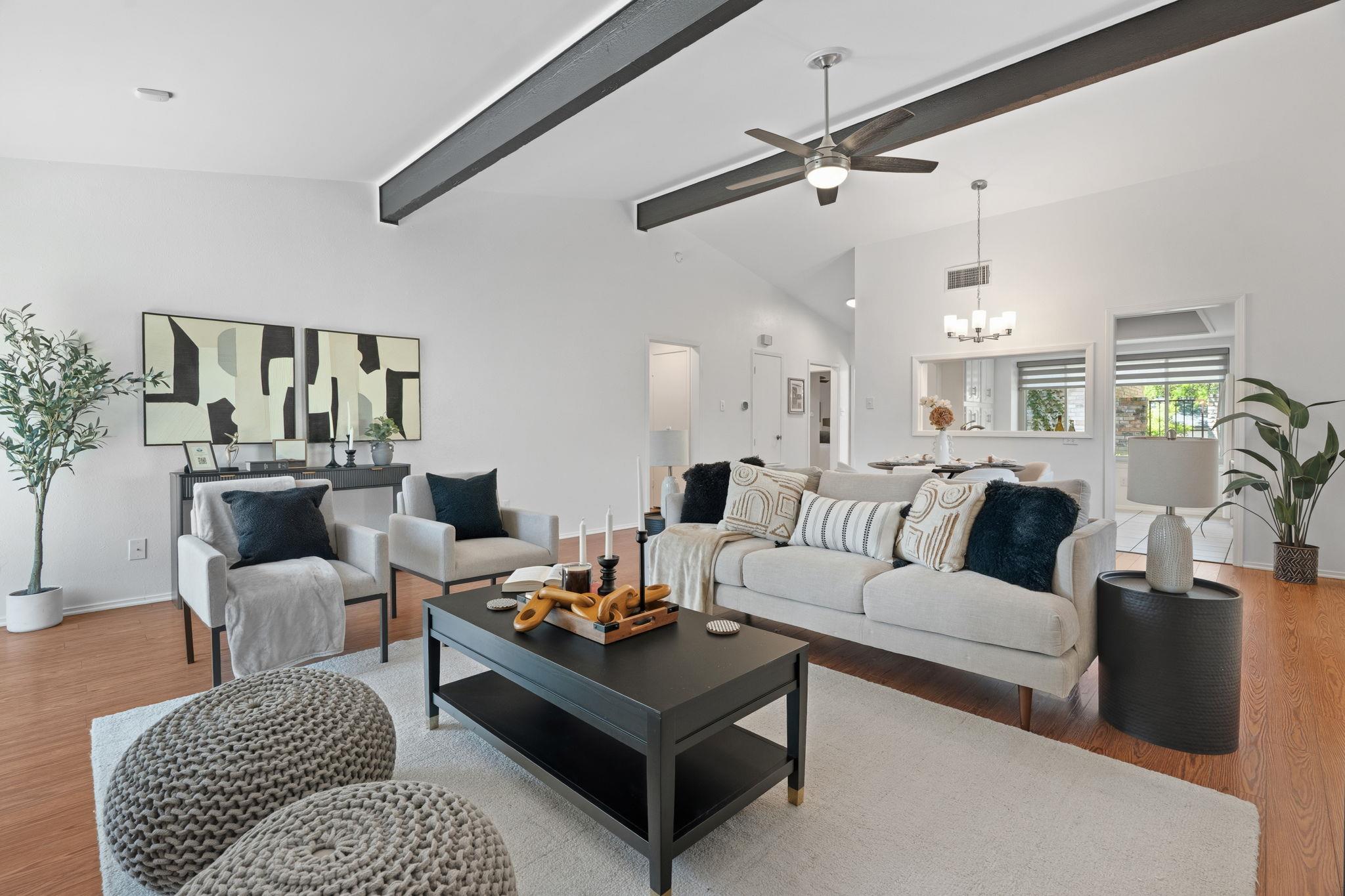 Exposed ceiling beams accent the airy living spac