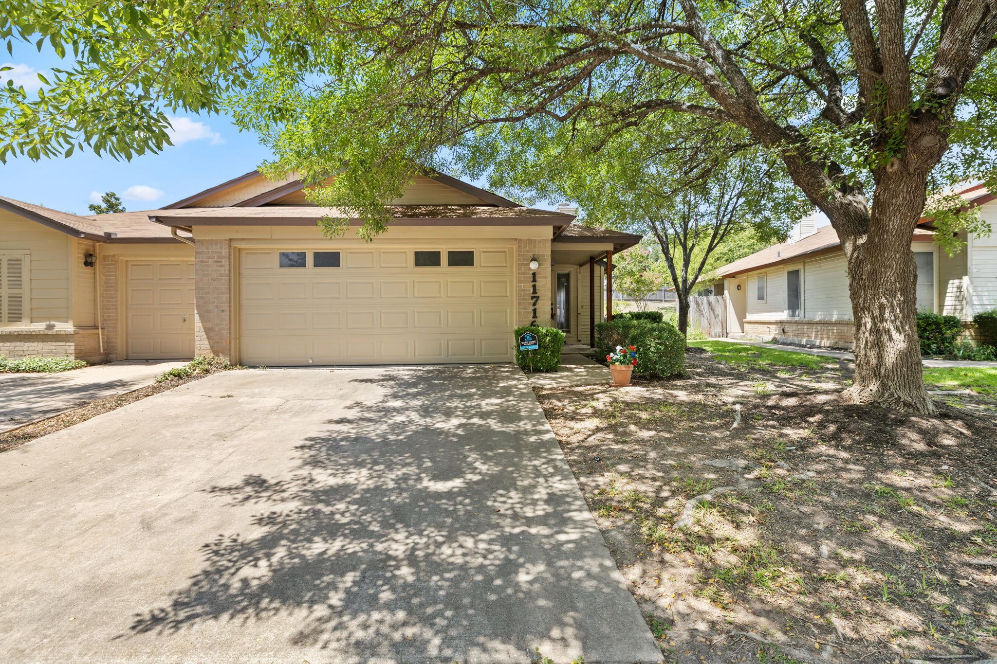 Ranch-style house with driveway, brick siding, an