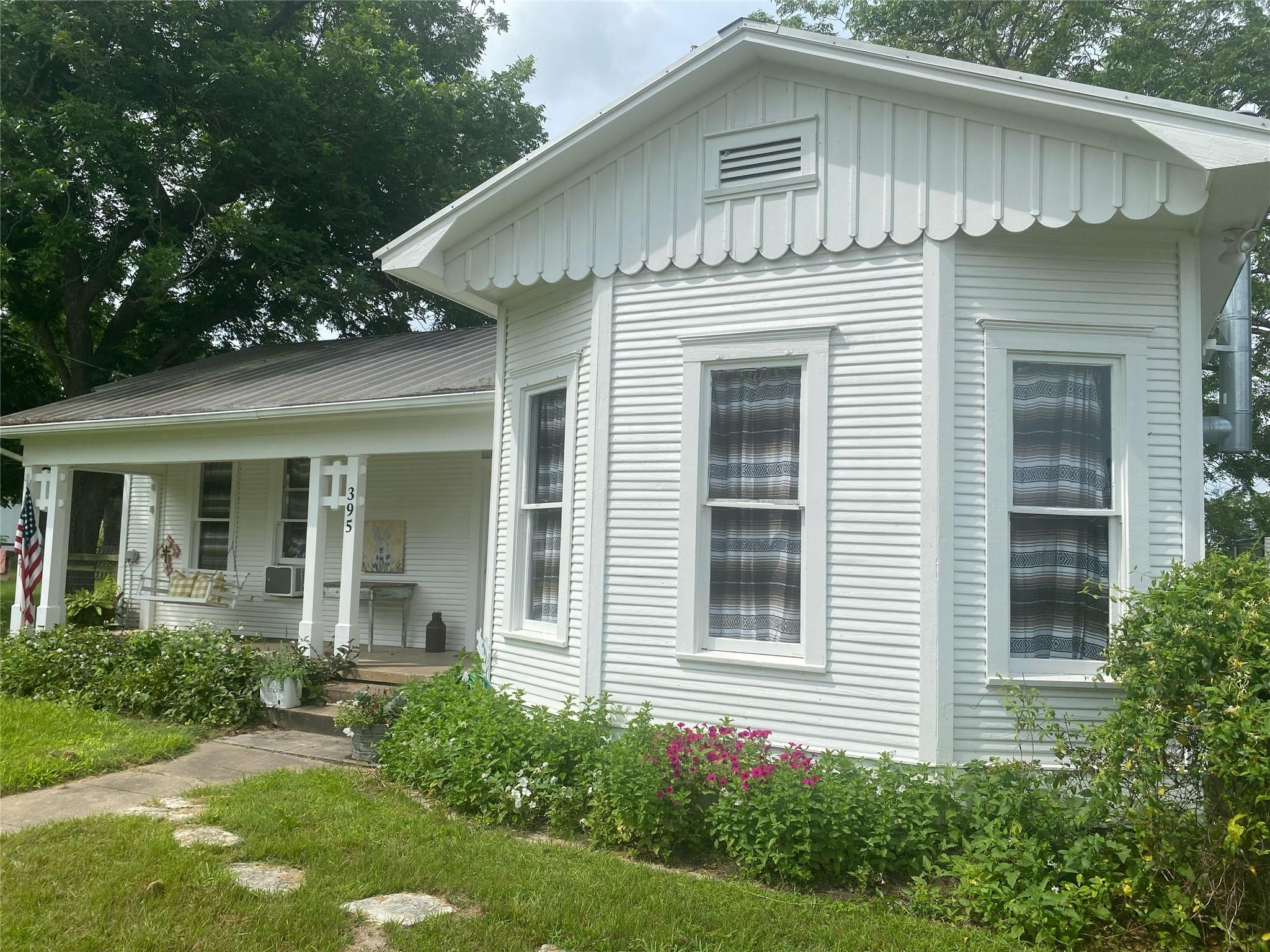 View of front of property featuring a porch, boar