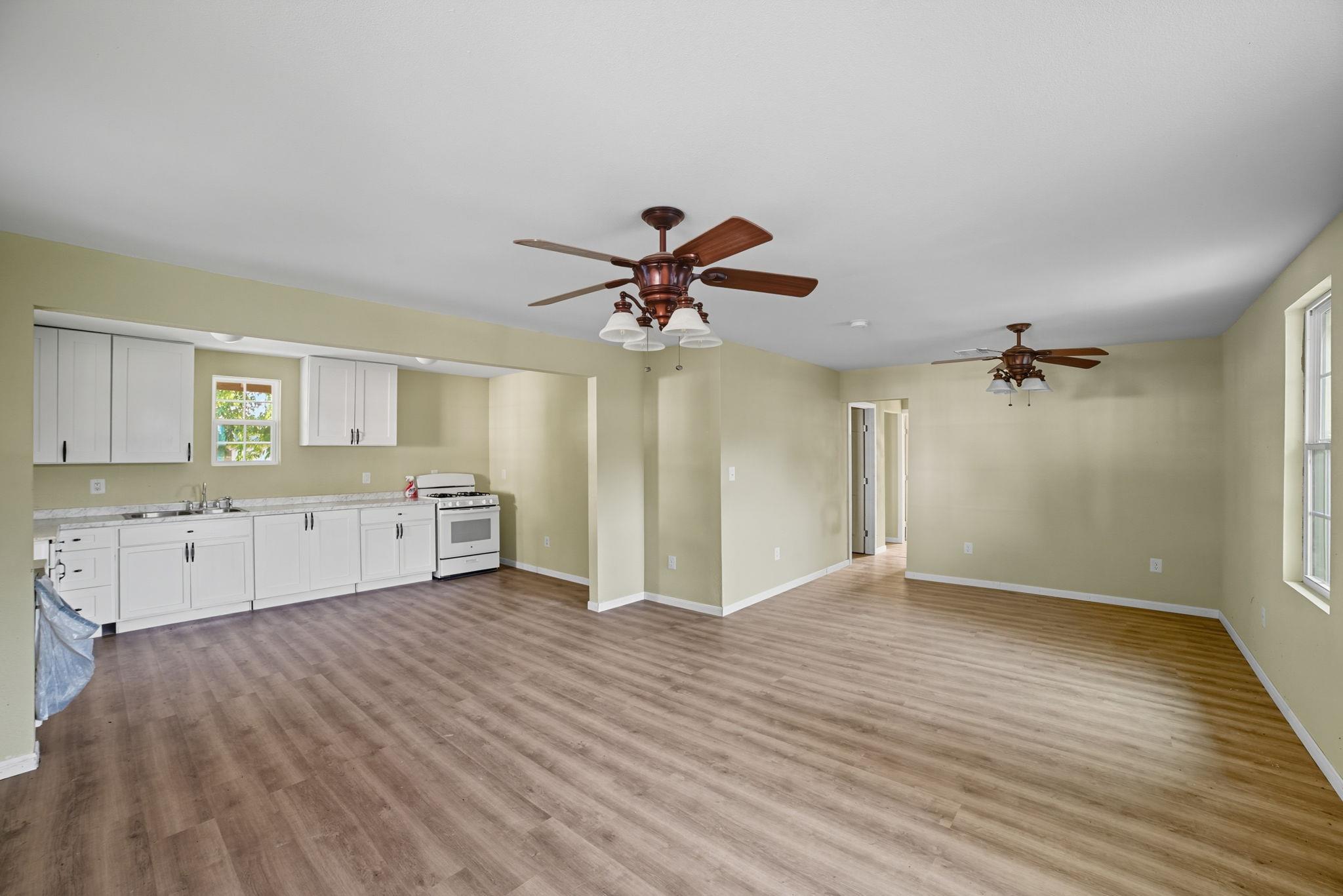 Unfurnished living room featuring light wood fini