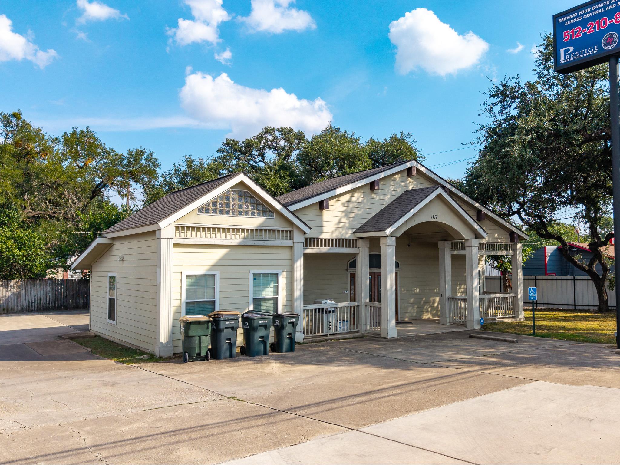 View of front of property featuring roof with shi
