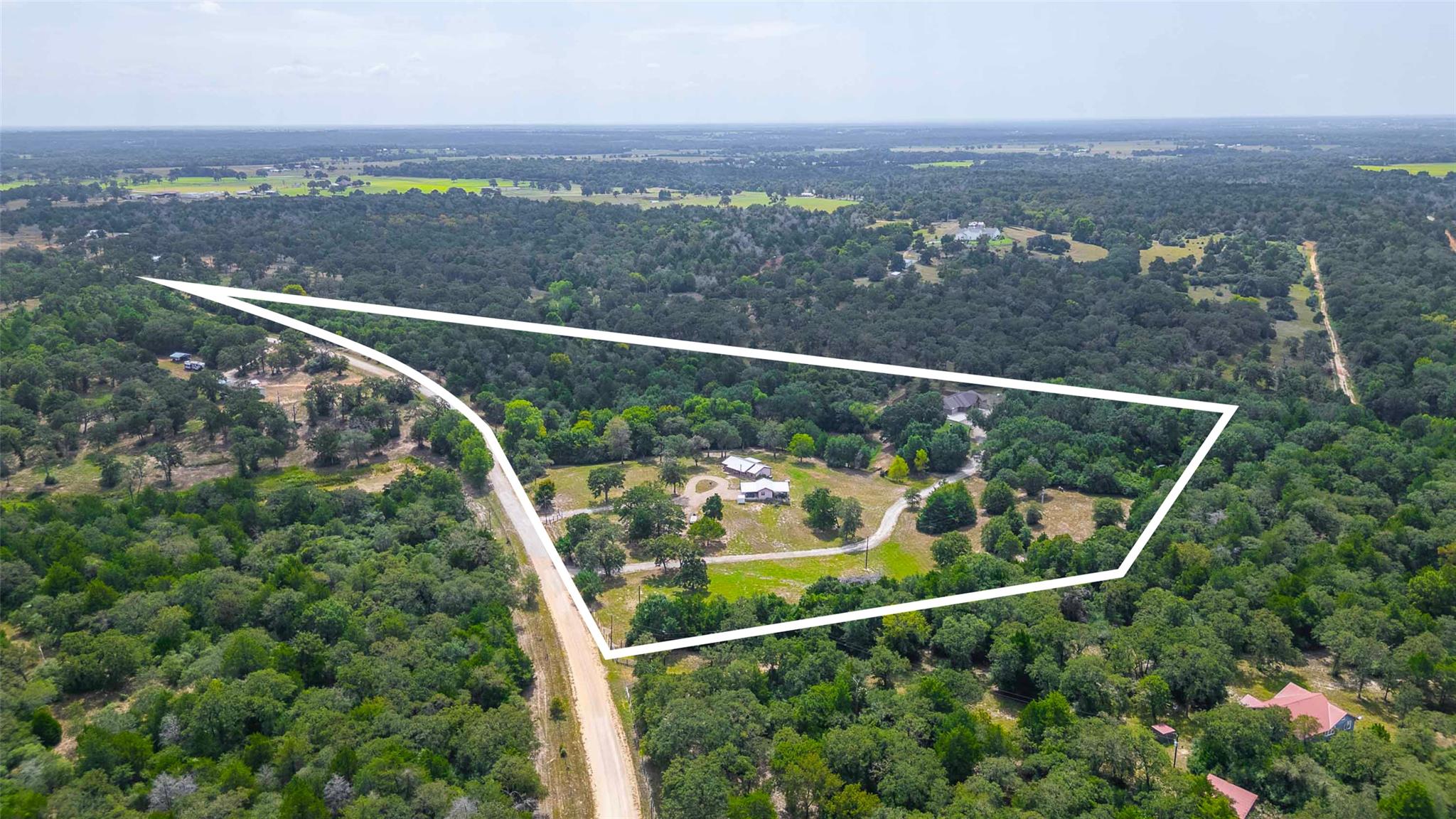 Aerial view of property's location with a forest 
