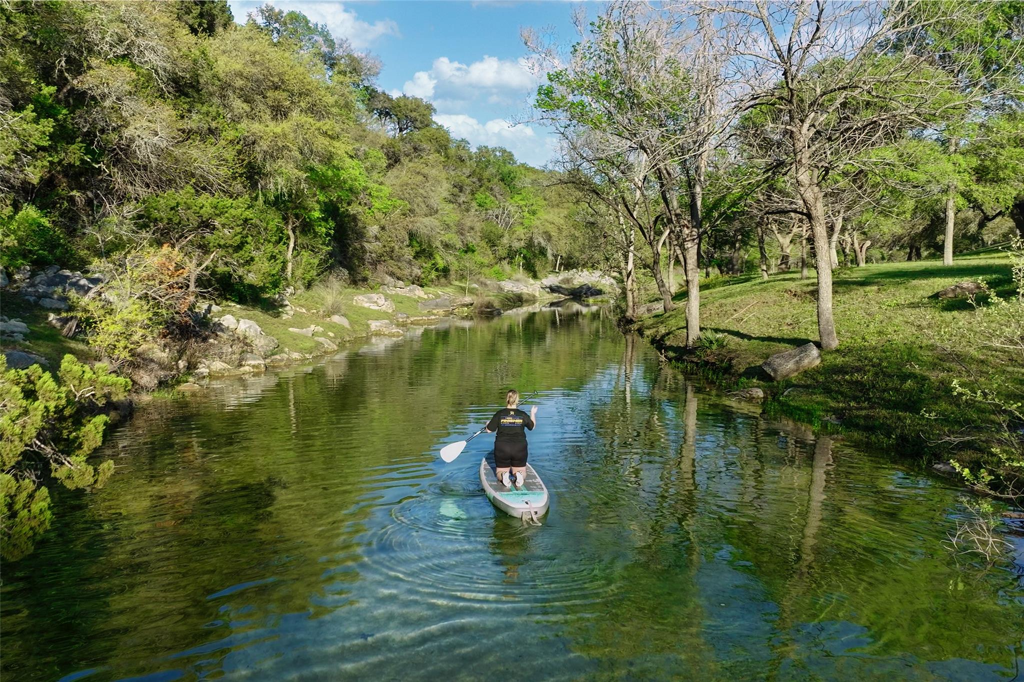 Natural waterway with clear water, surrounded by 