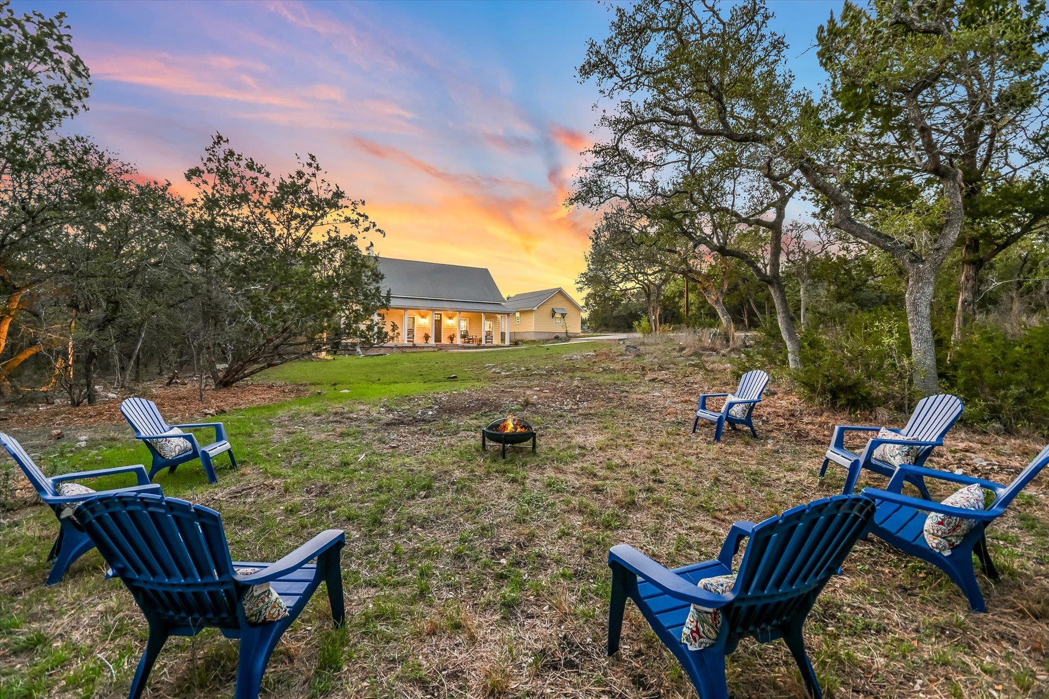 Yard at dusk featuring an outdoor fire pit and a 