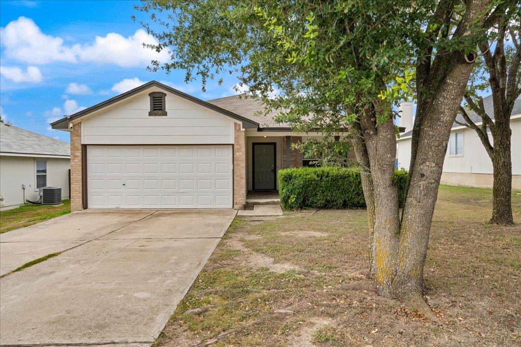 Ranch-style house featuring driveway, brick sidin