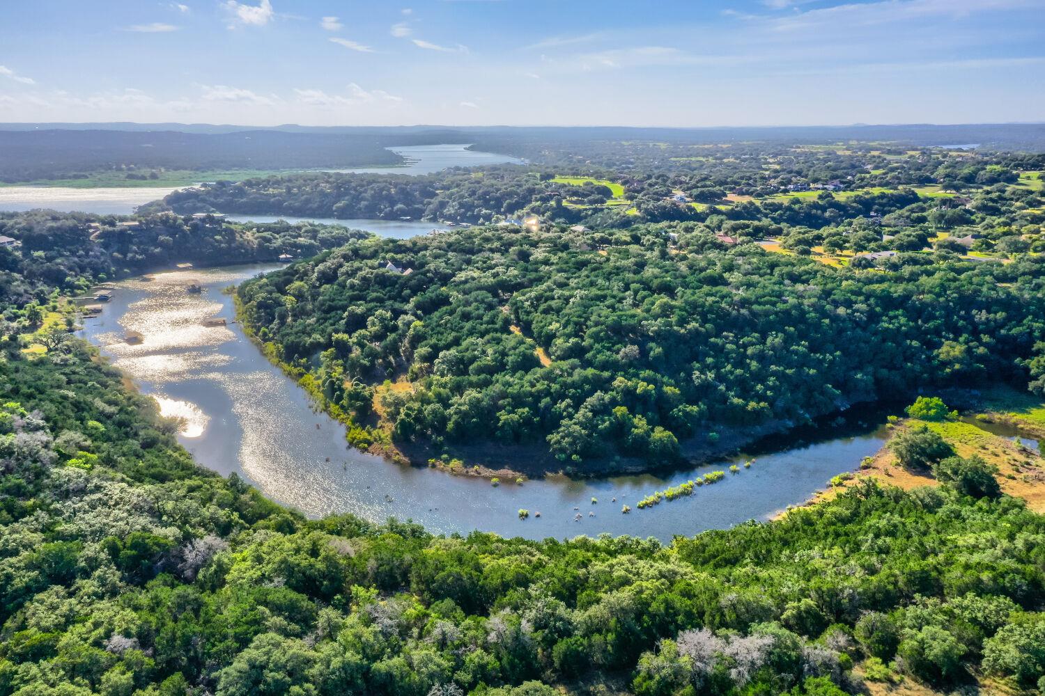 A tranquil river winds through a verdant landscap