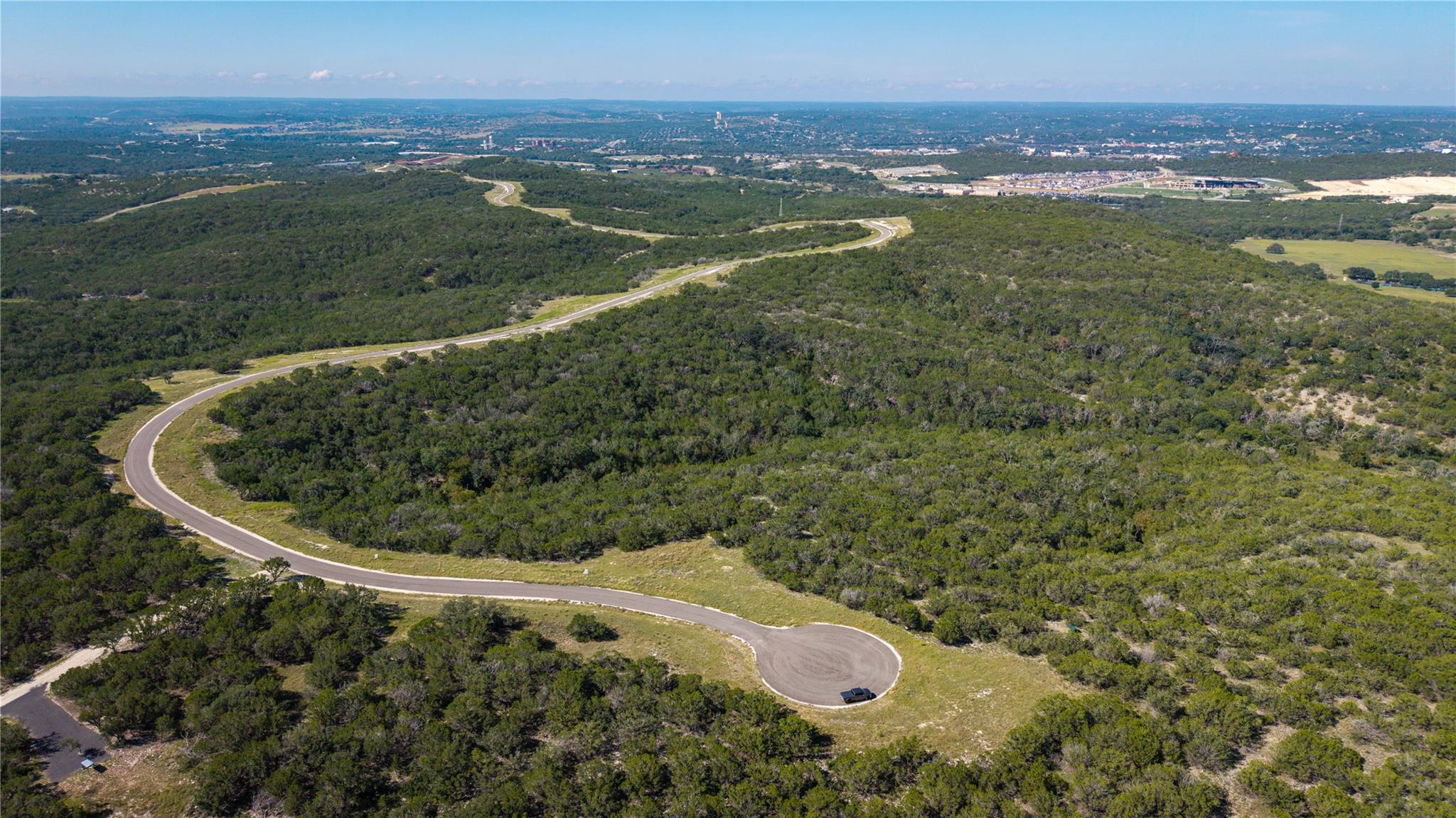 View of property location featuring a heavily woo