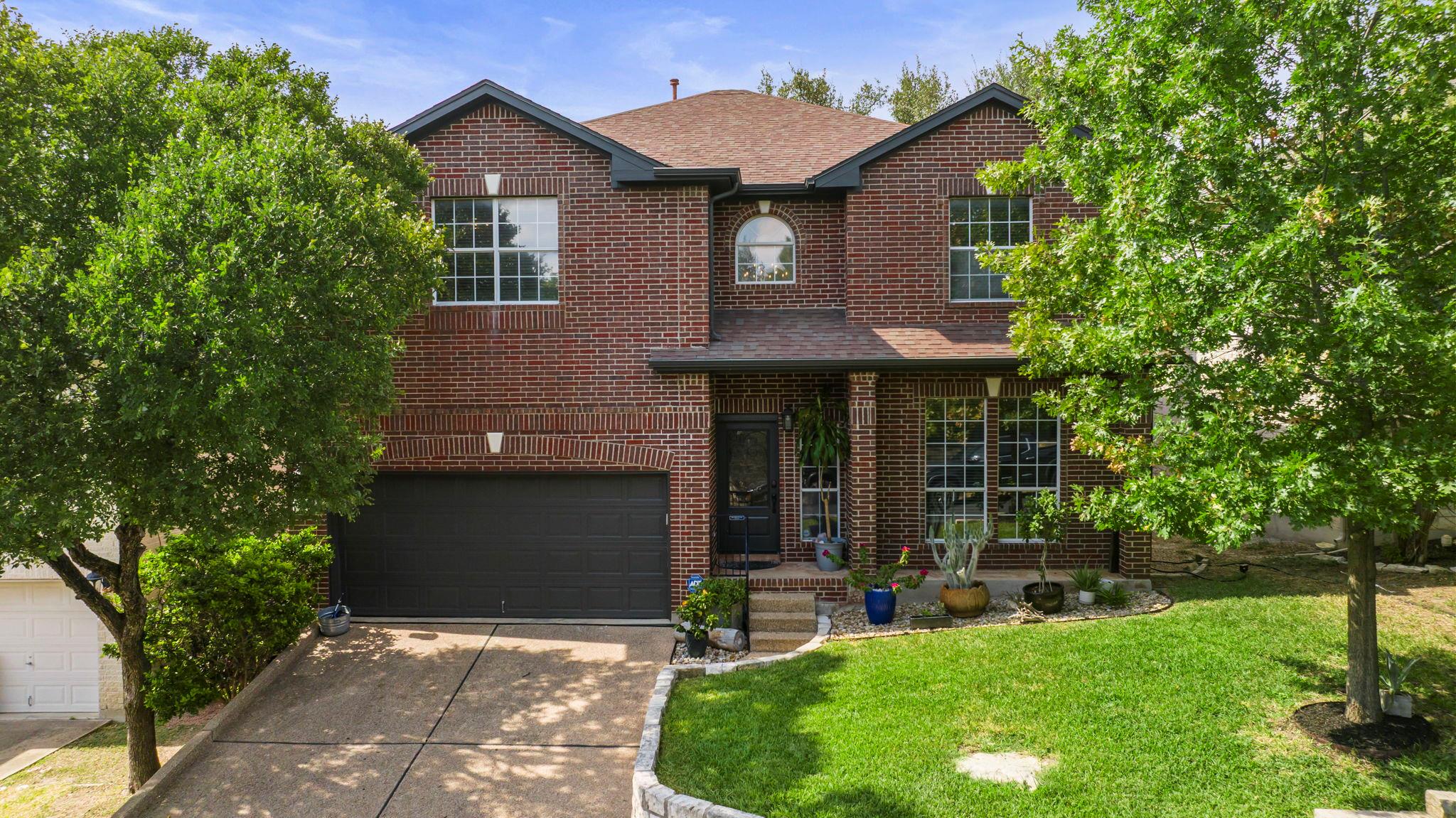 Traditional-style home with brick siding, roof wi