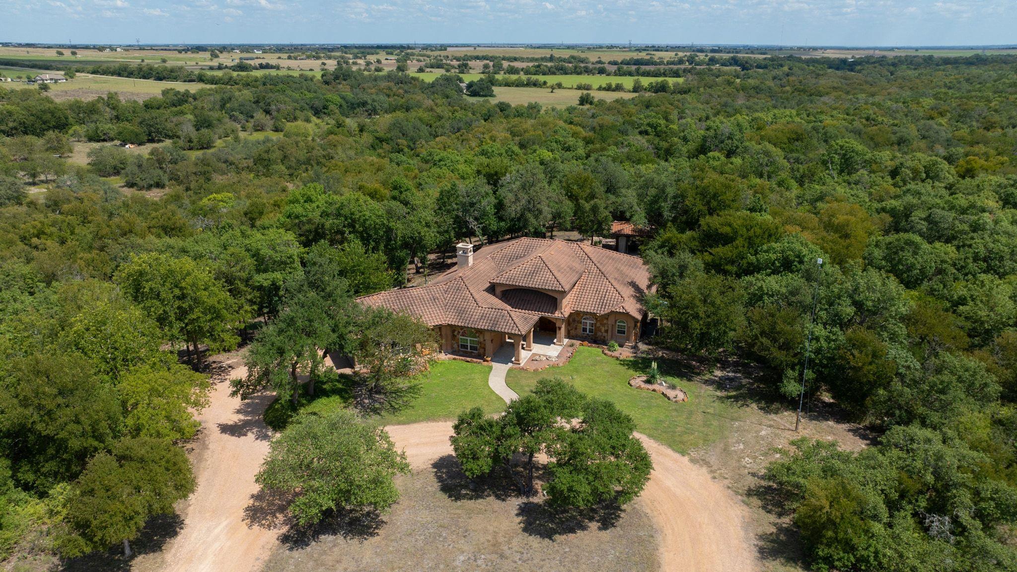 Aerial view of property and surrounding area with
