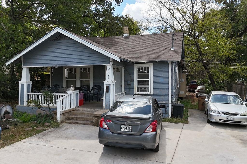 View of front of house featuring a porch, roof wi