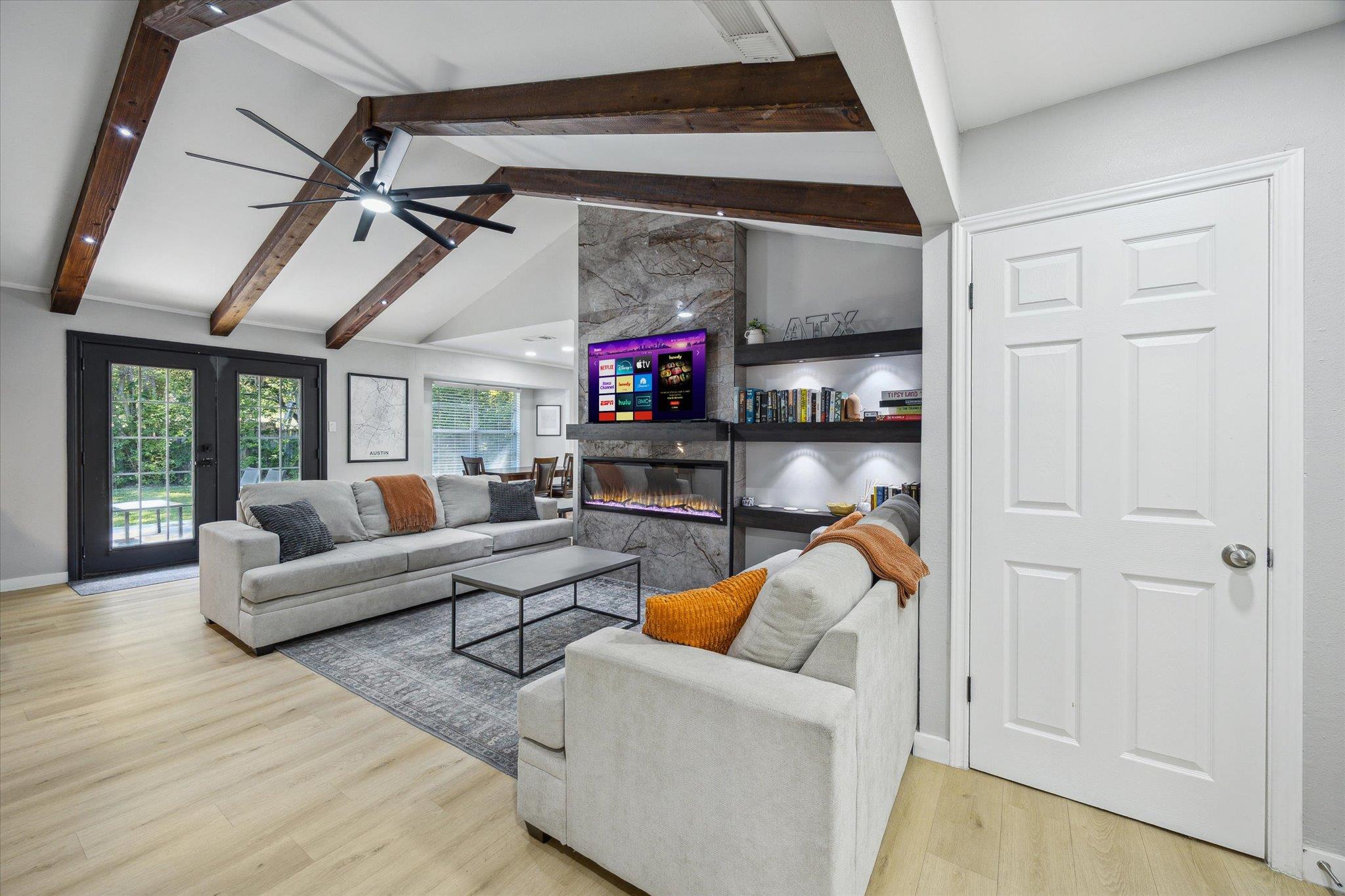 Living room with light wood-style floors, a large