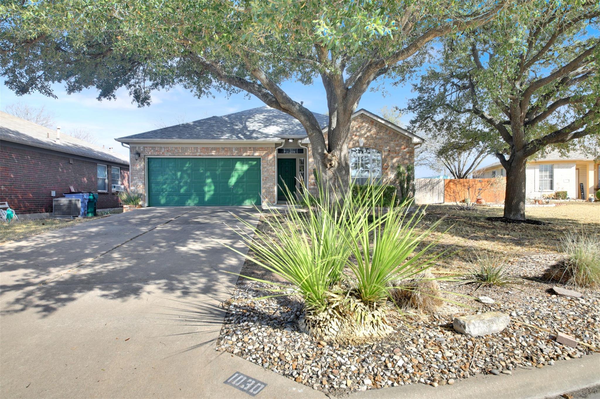 Ranch-style home with brick siding, driveway, and