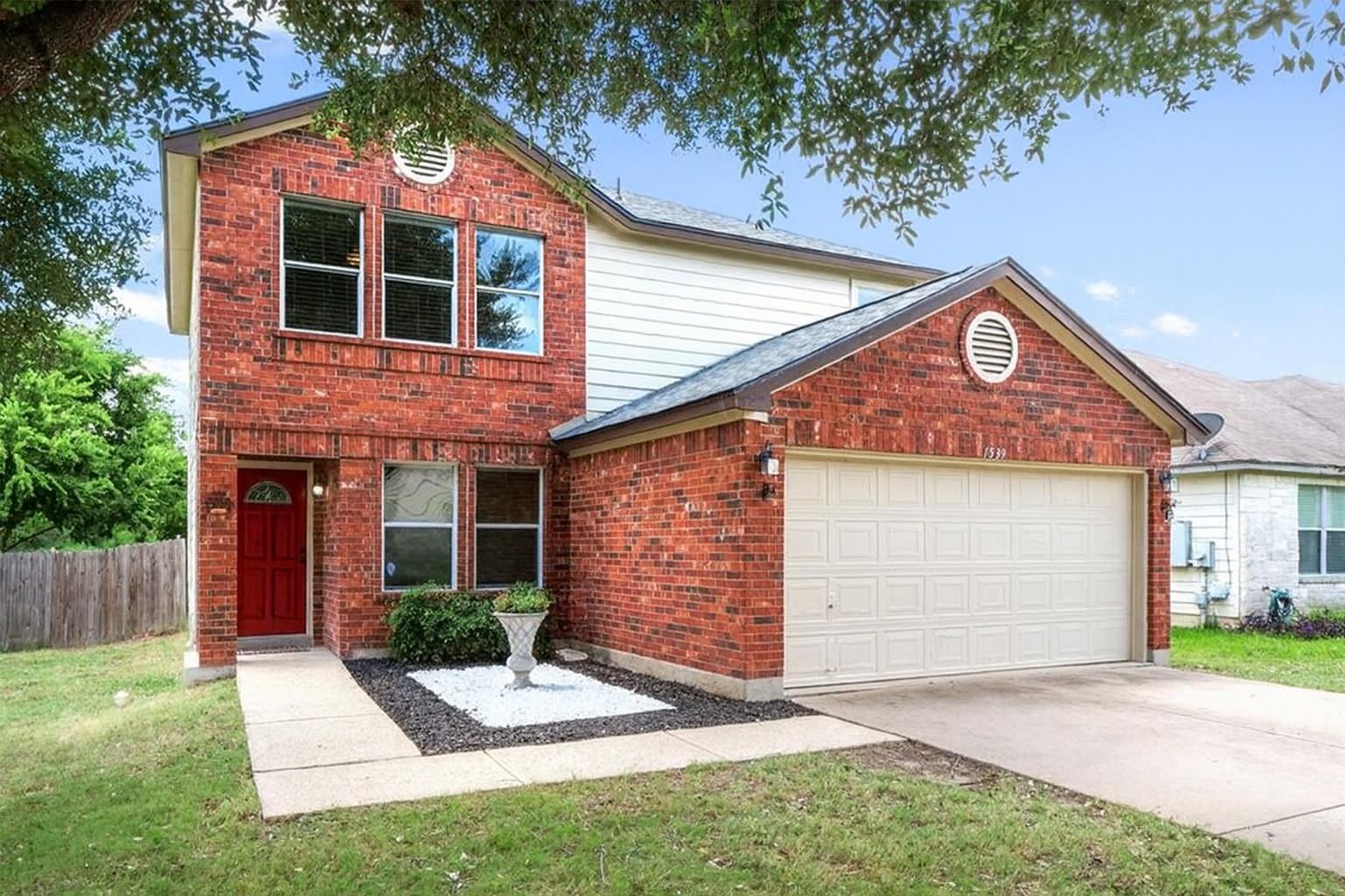 Traditional-style house with brick siding, an att