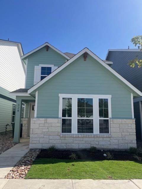 View of side of property with stone siding