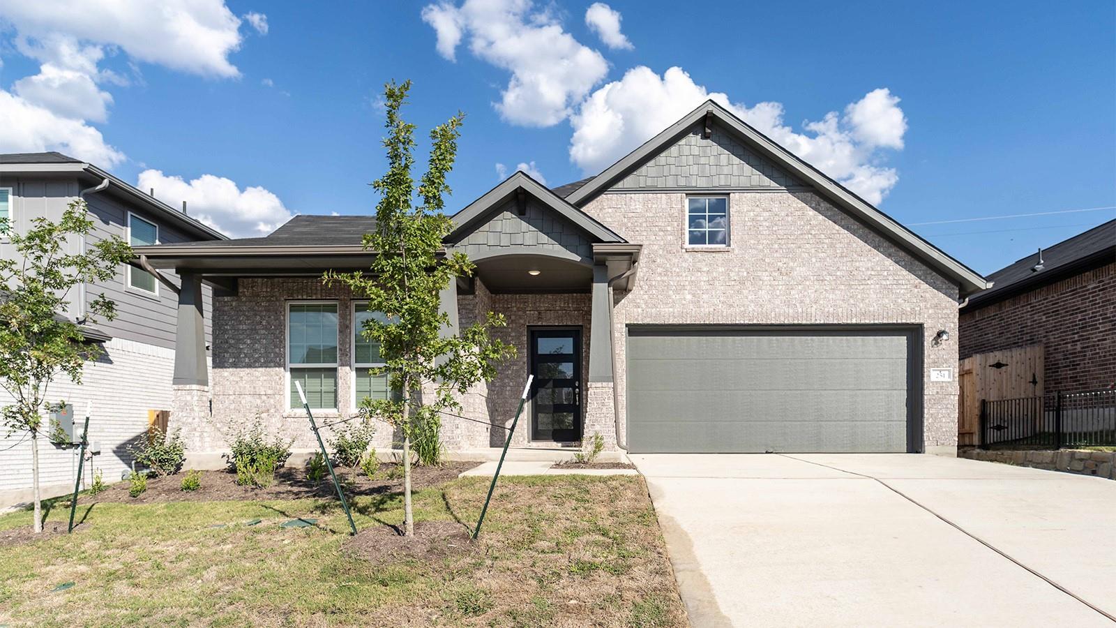 Craftsman inspired home with concrete driveway, b