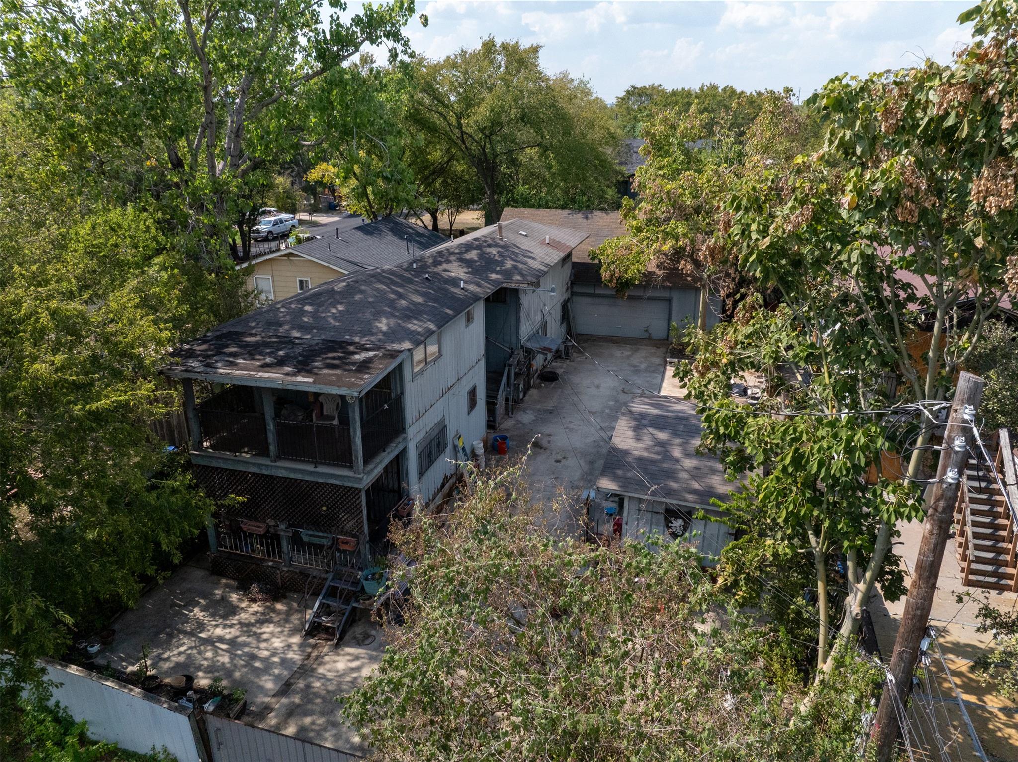 View of subject property featuring a tree filled 
