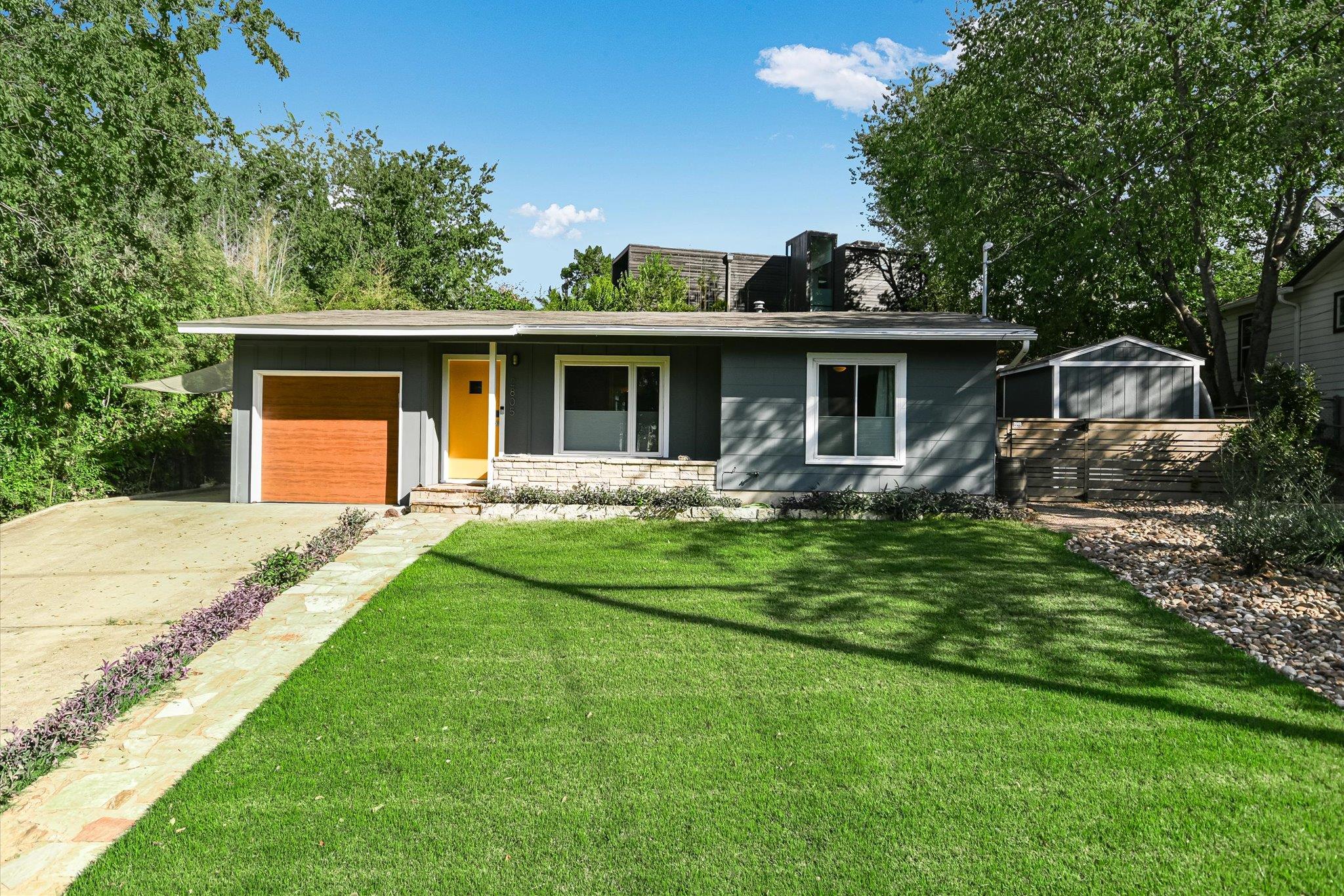 View of front facade with a front lawn, a porch, 