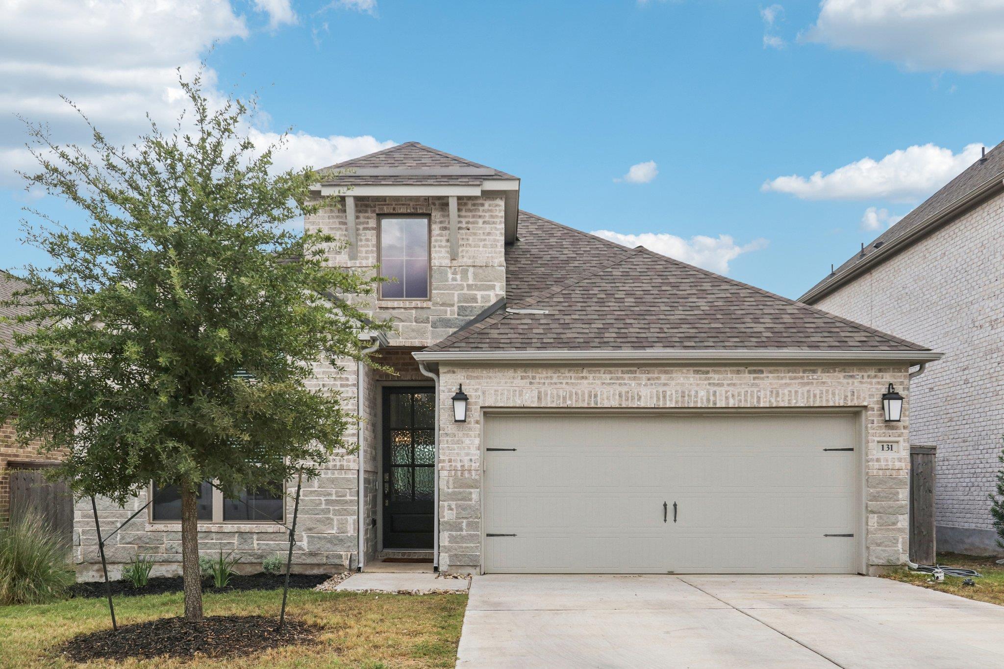 French provincial home featuring a shingled roof,