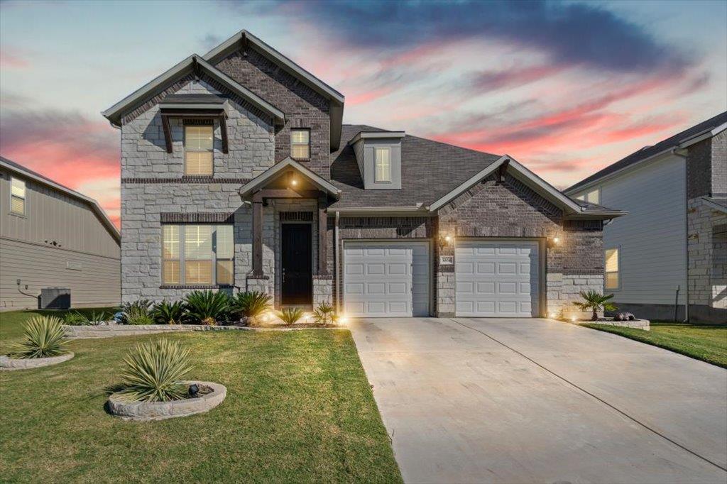 View of front of house featuring stone siding, dr