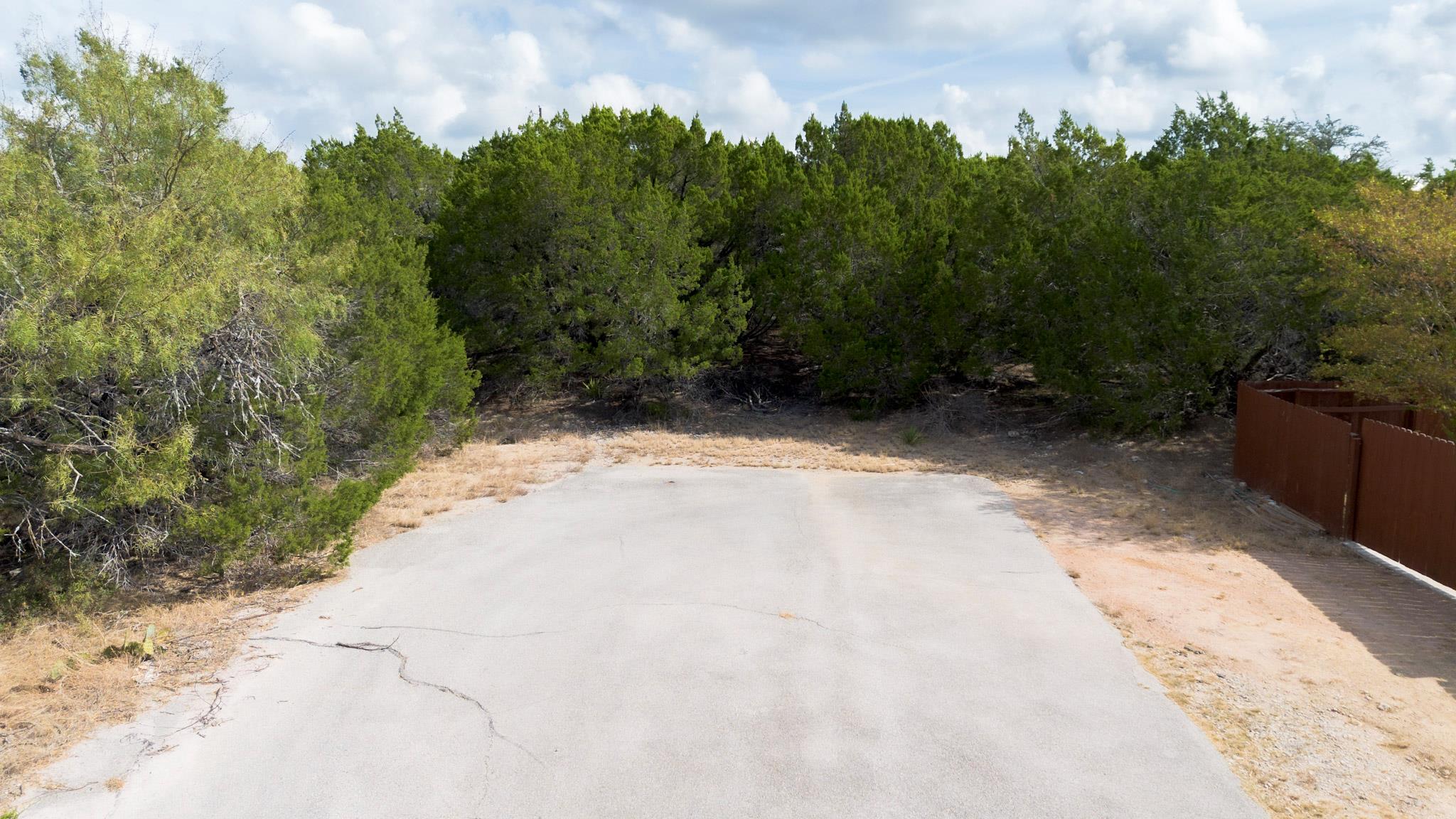 View of asphalt road featuring a view of trees