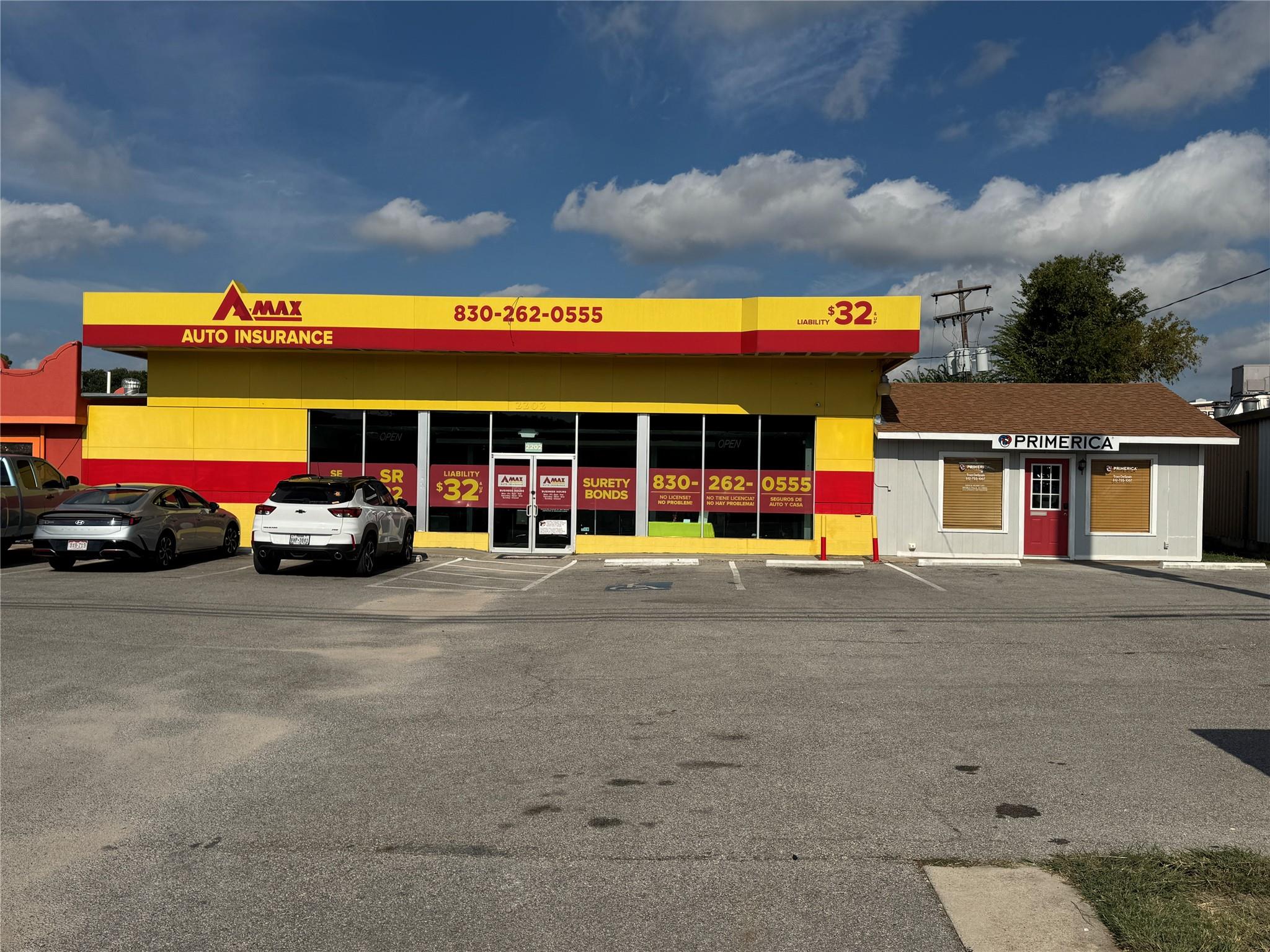 View of building exterior with uncovered parking