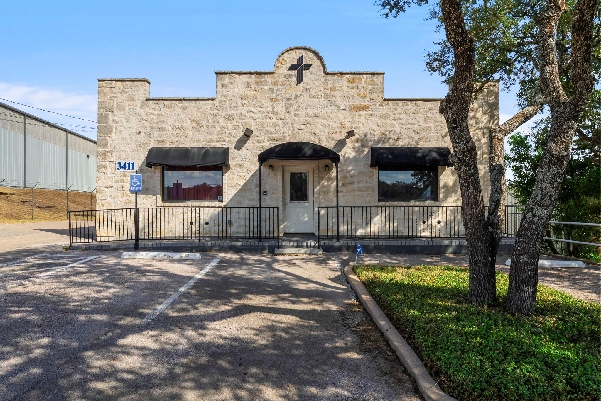View of front of house featuring stone siding and