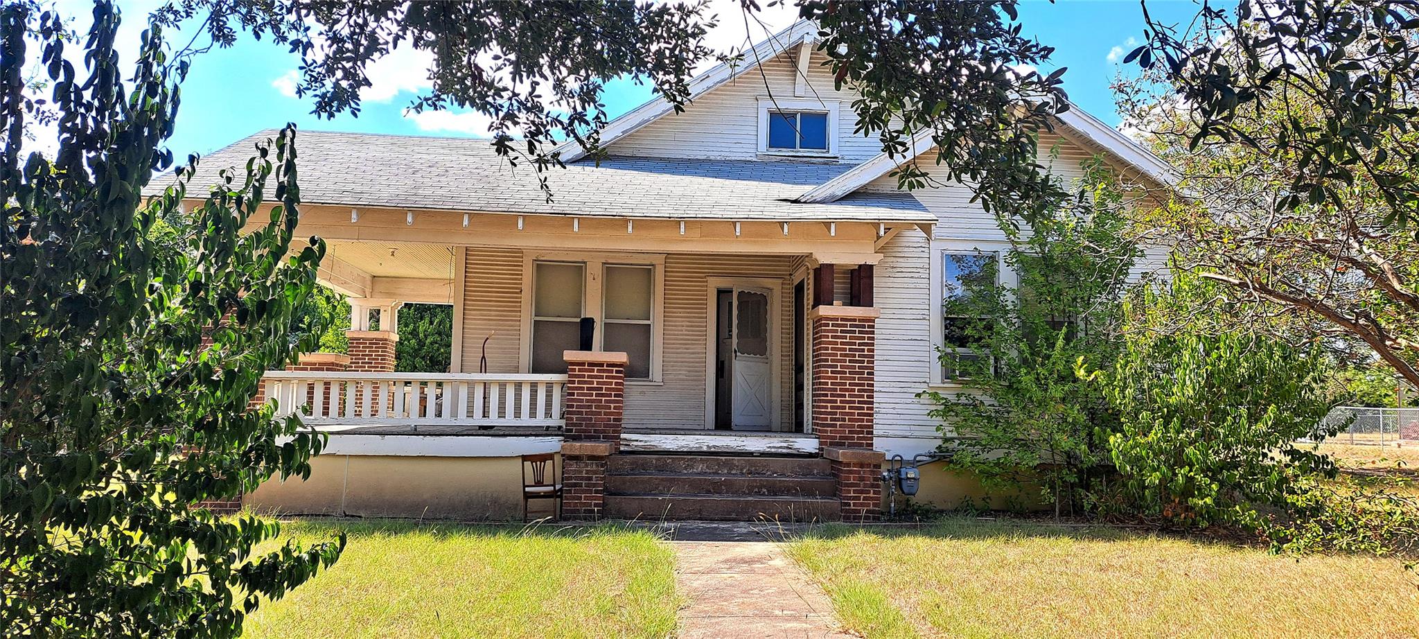 Bungalow featuring a porch, roof with shingles, a