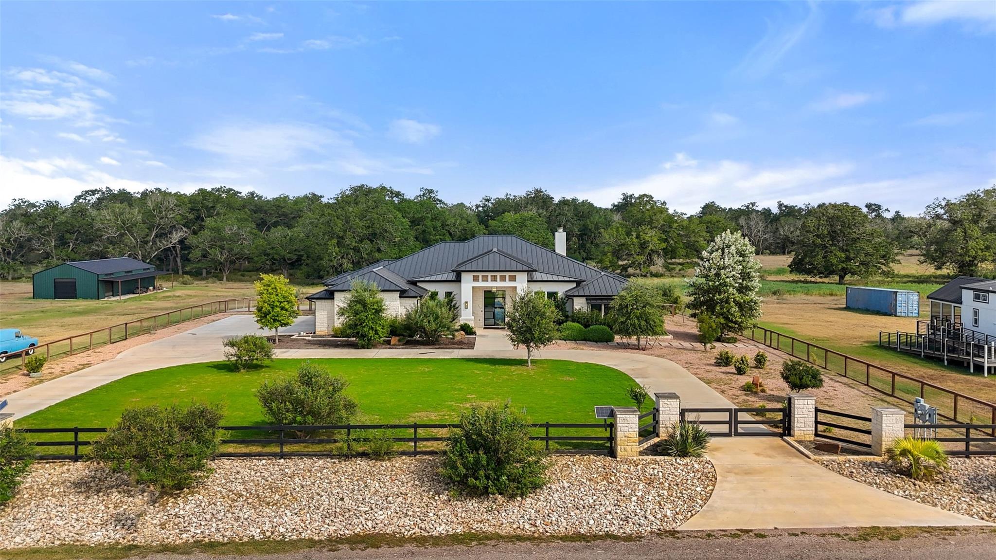 A grand estate with a sweeping driveway, manicure